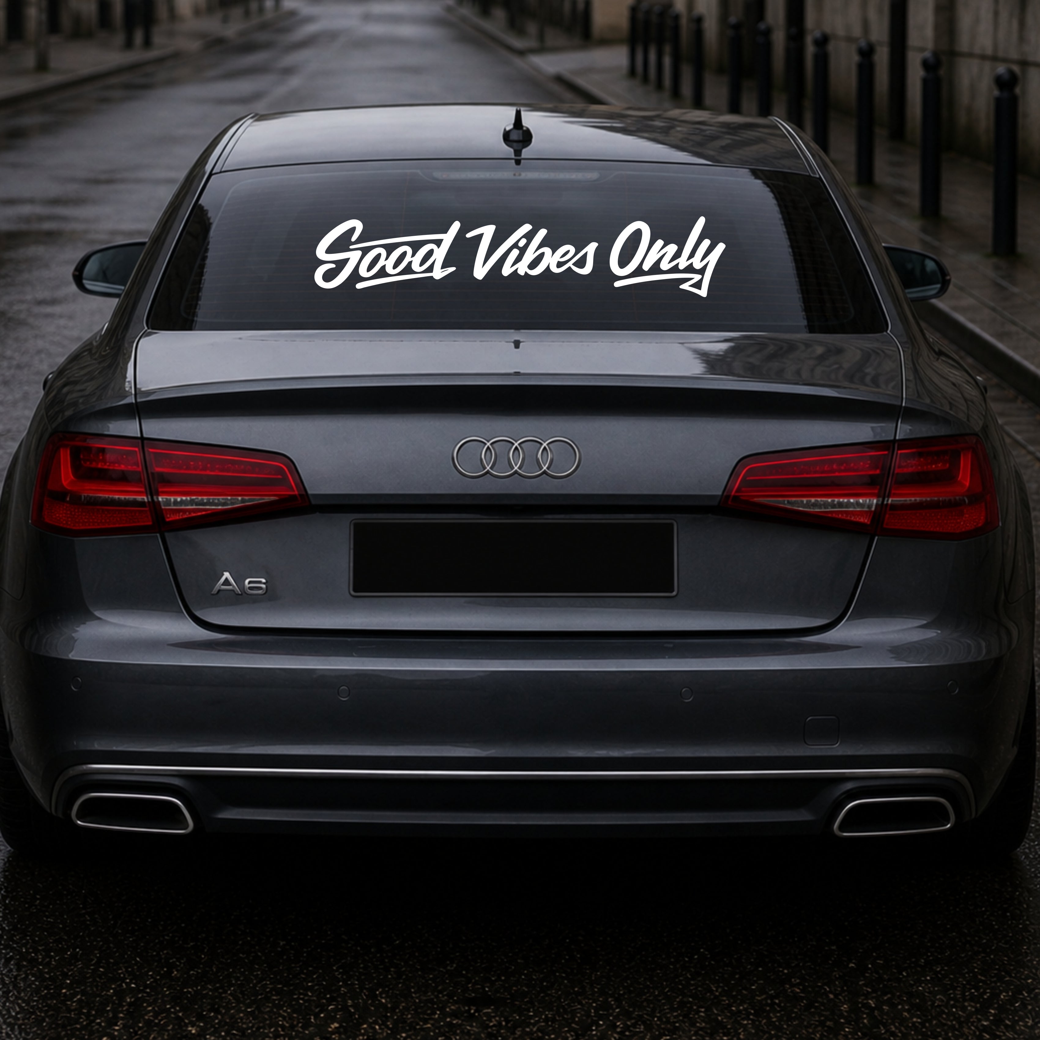 Audi car with 'Good Vibes Only' decal on the back window.