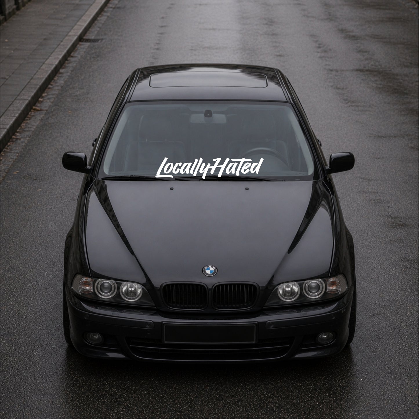 Black BMW car on a road with 'LocallyHated' decal