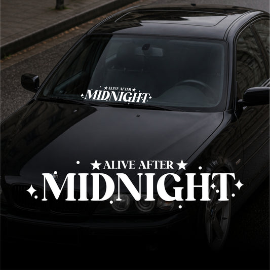 Black car with 'Alive After Midnight' decal on the windshield and hood.