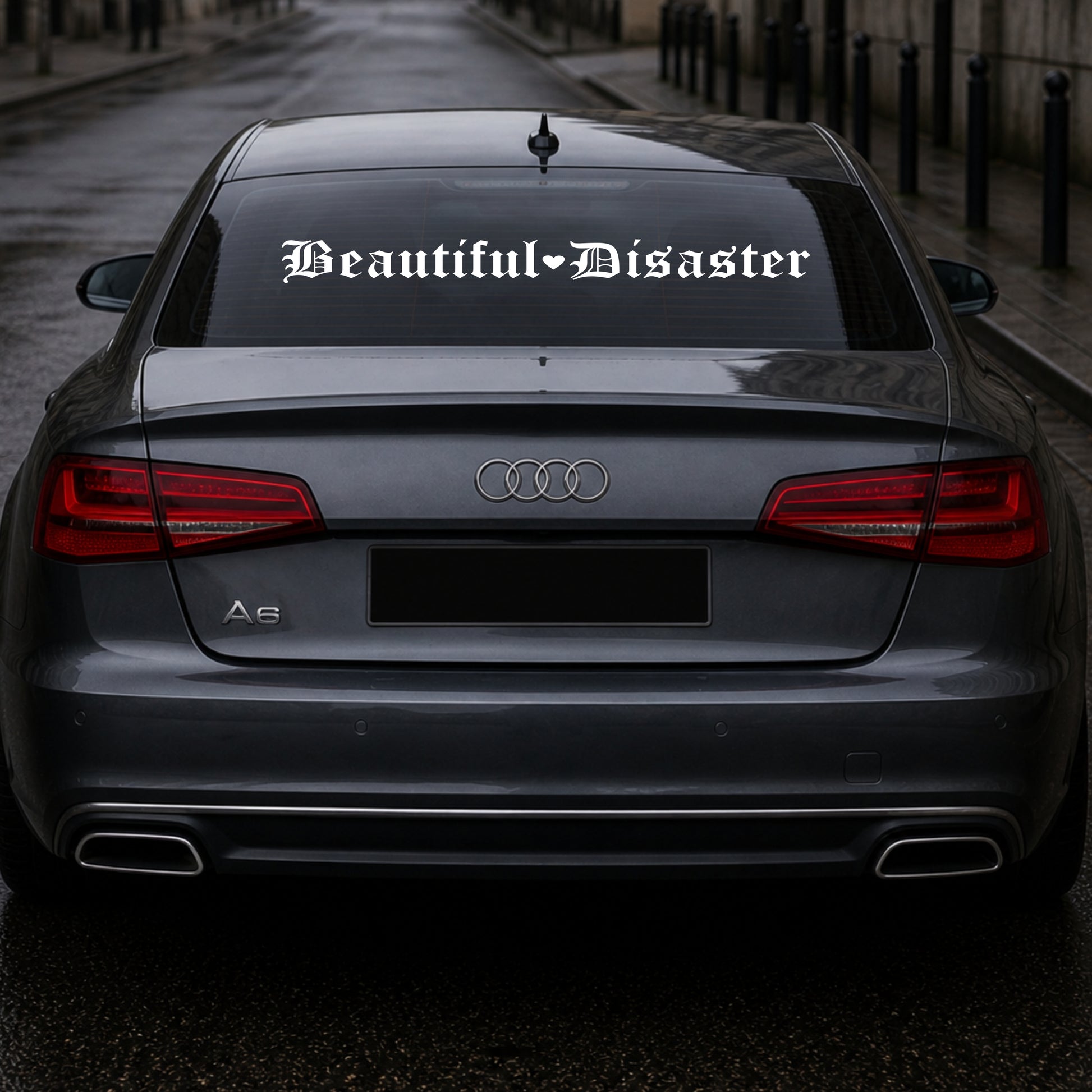Audi car with 'Beautiful Disaster' decal on the back window.