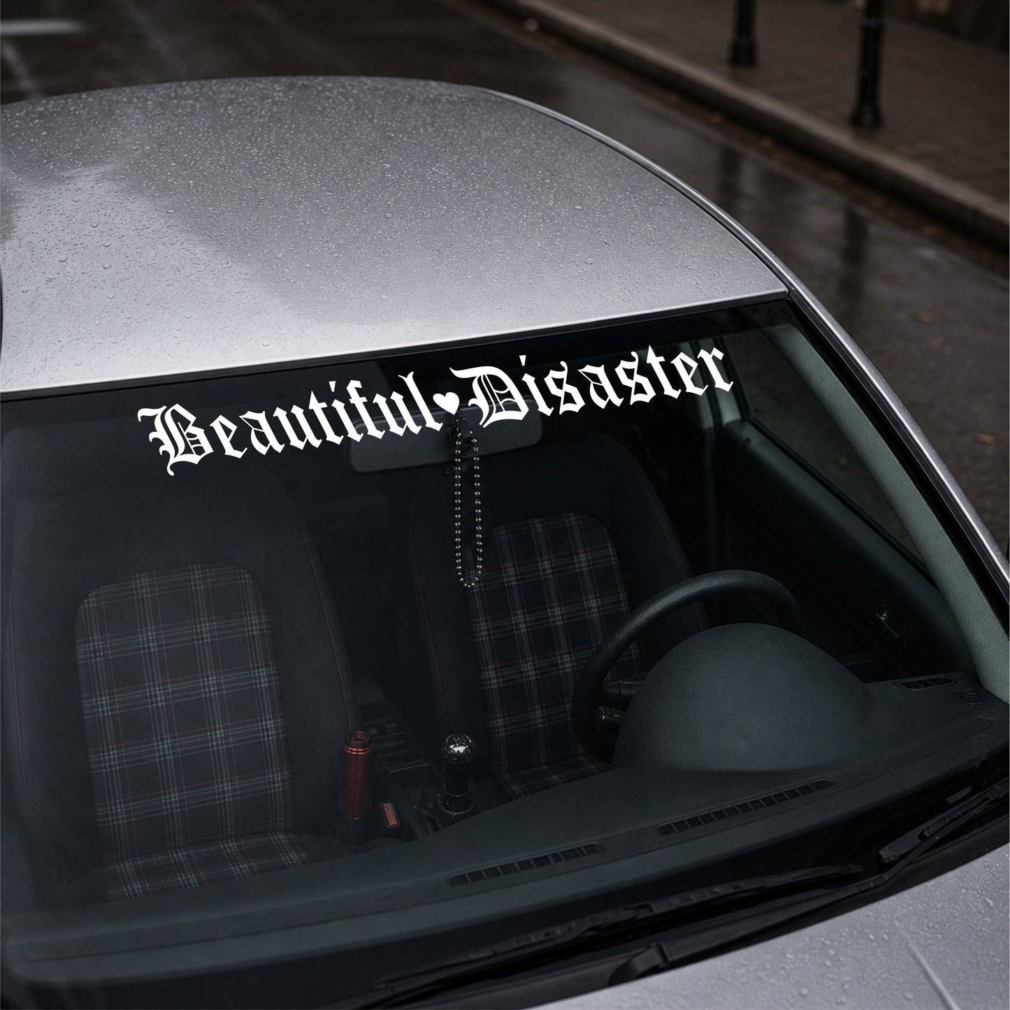Car with 'Beautiful Disaster' decal on the windshield