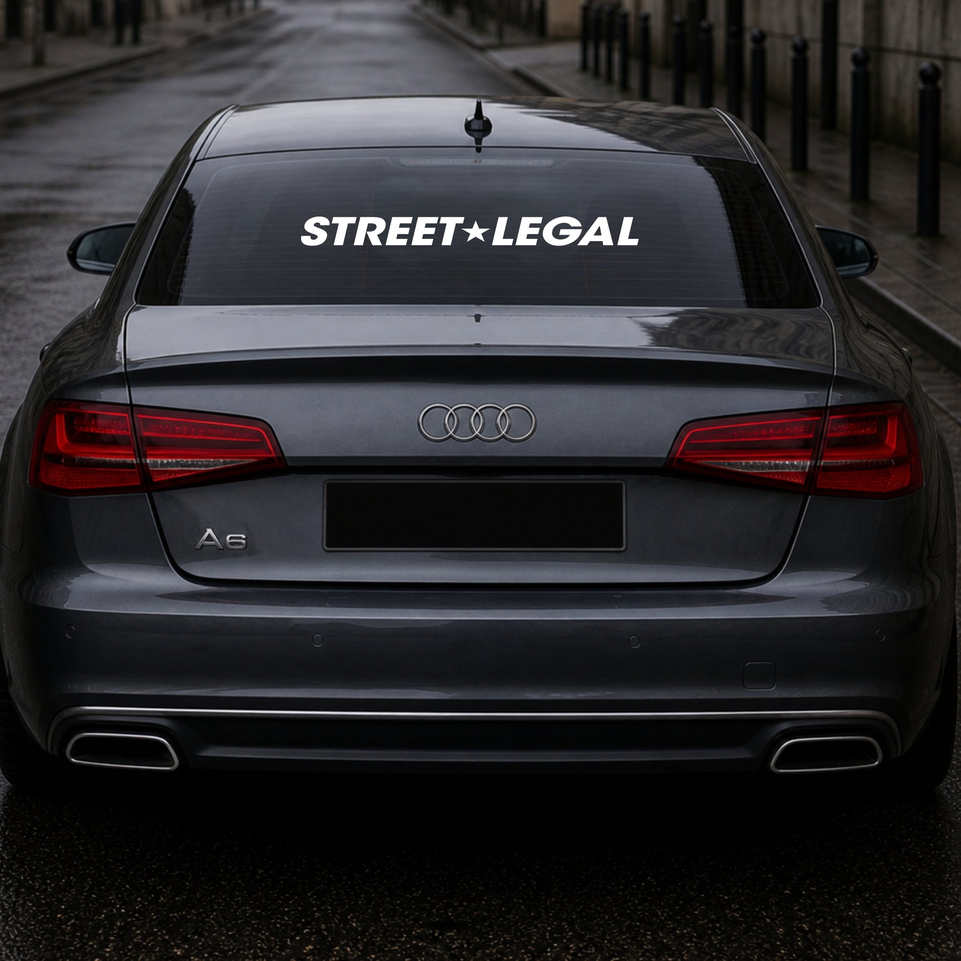 Back view of an Audi car with 'Street Legal' decal on a dark street.