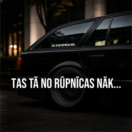 Black car with text on the window and side, set against a dark background.