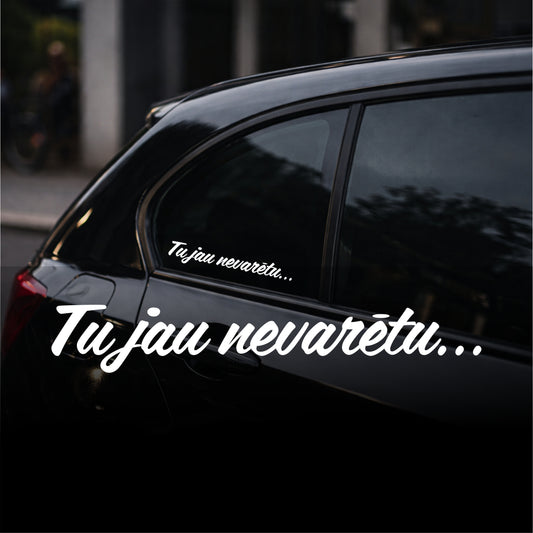 Black car with white text decal on a blurred street background