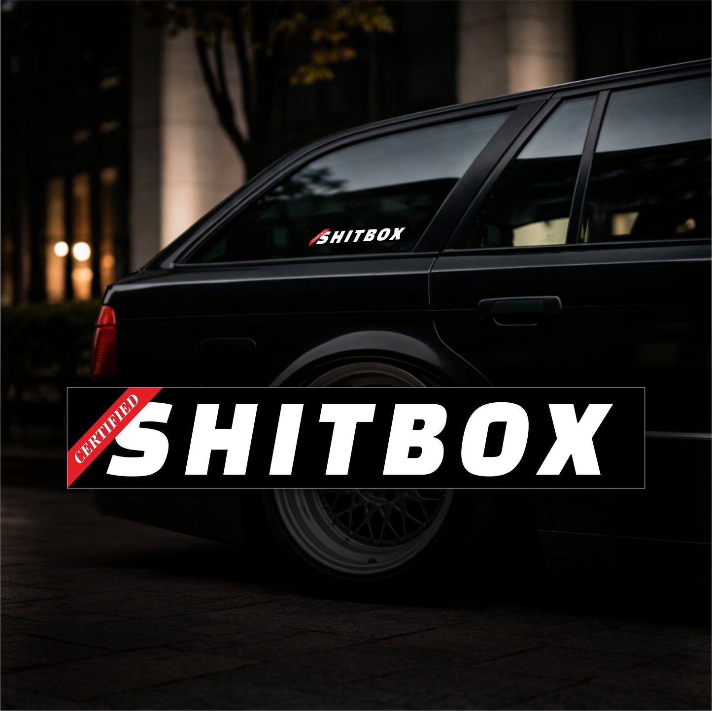 Black car with 'SHITBOX' decal on a dark background