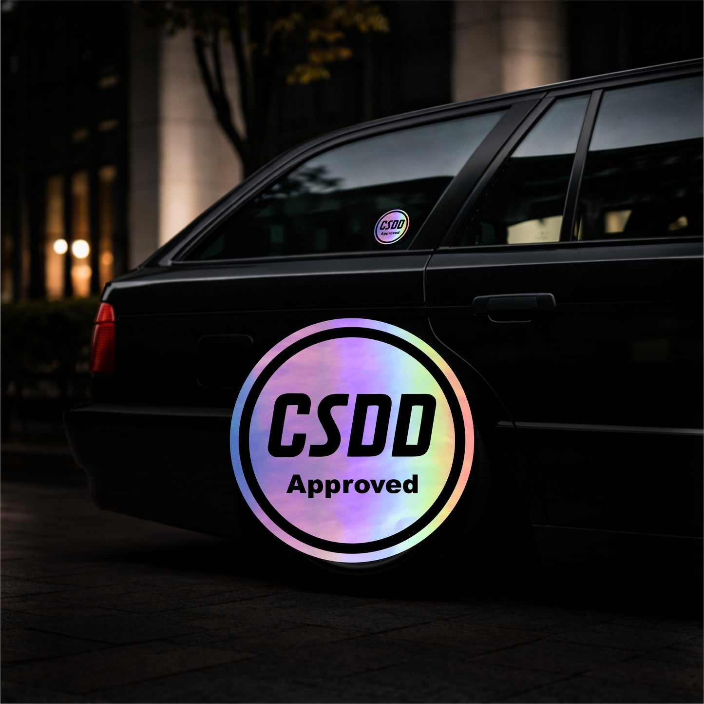 Car with a rainbow-colored 'CSDD Approved' sticker on the back