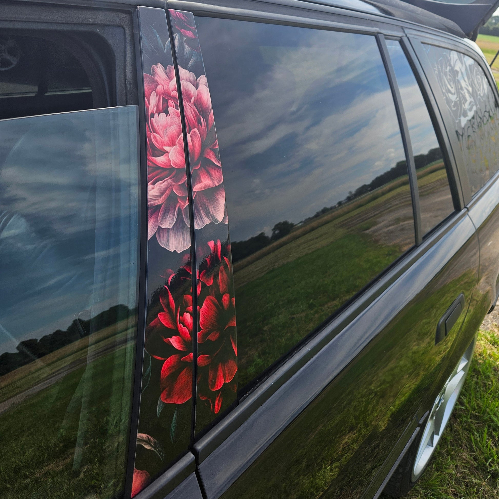 Car window with floral decal on a road