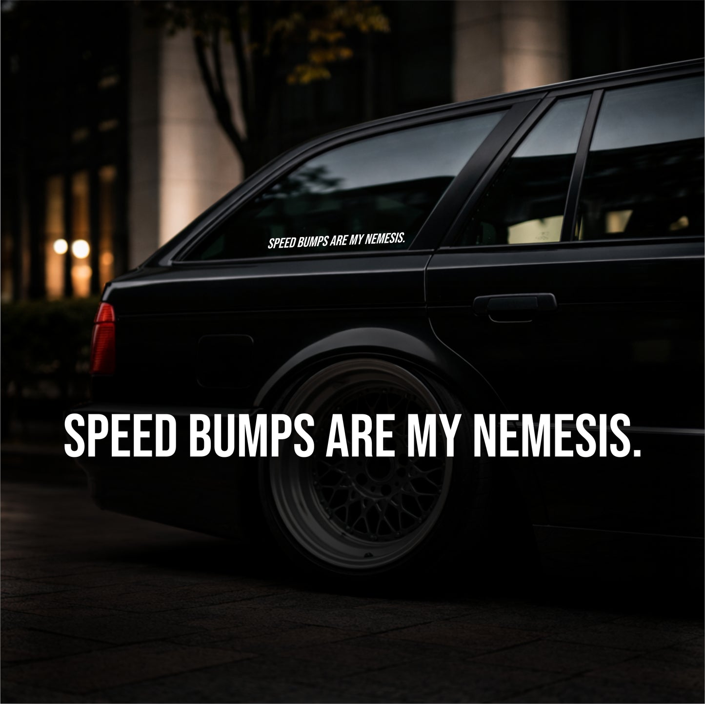Black car with 'Speed Bumps are my Nemesis' sticker on a dark background