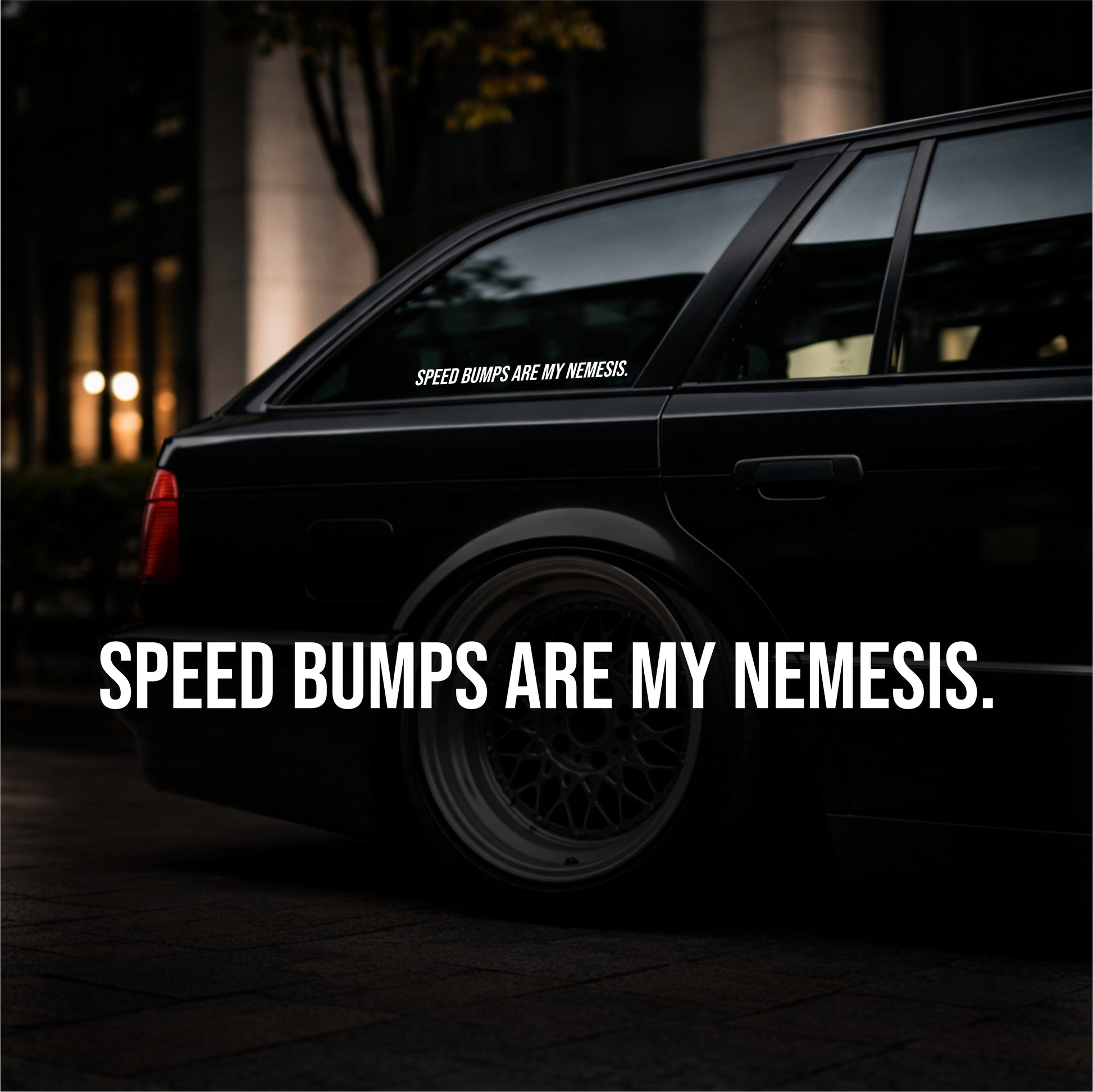 Black car with 'Speed Bumps are my Nemesis' sticker on a dark background