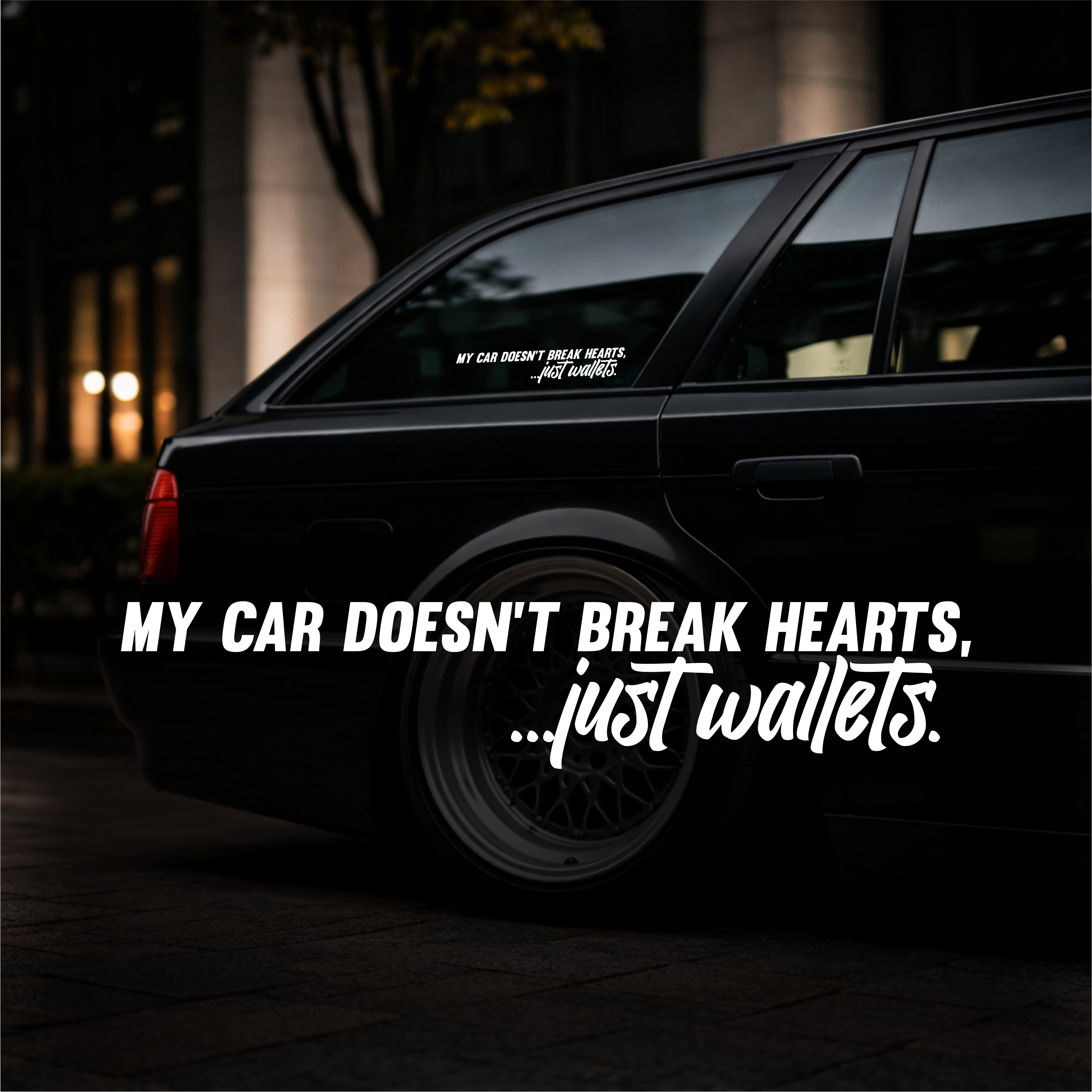 Black car with humorous text sticker at night