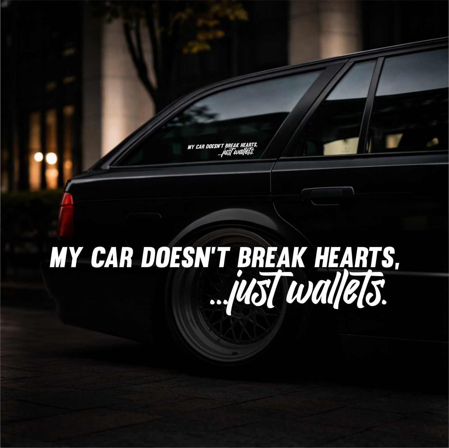 Black car with humorous text sticker at night