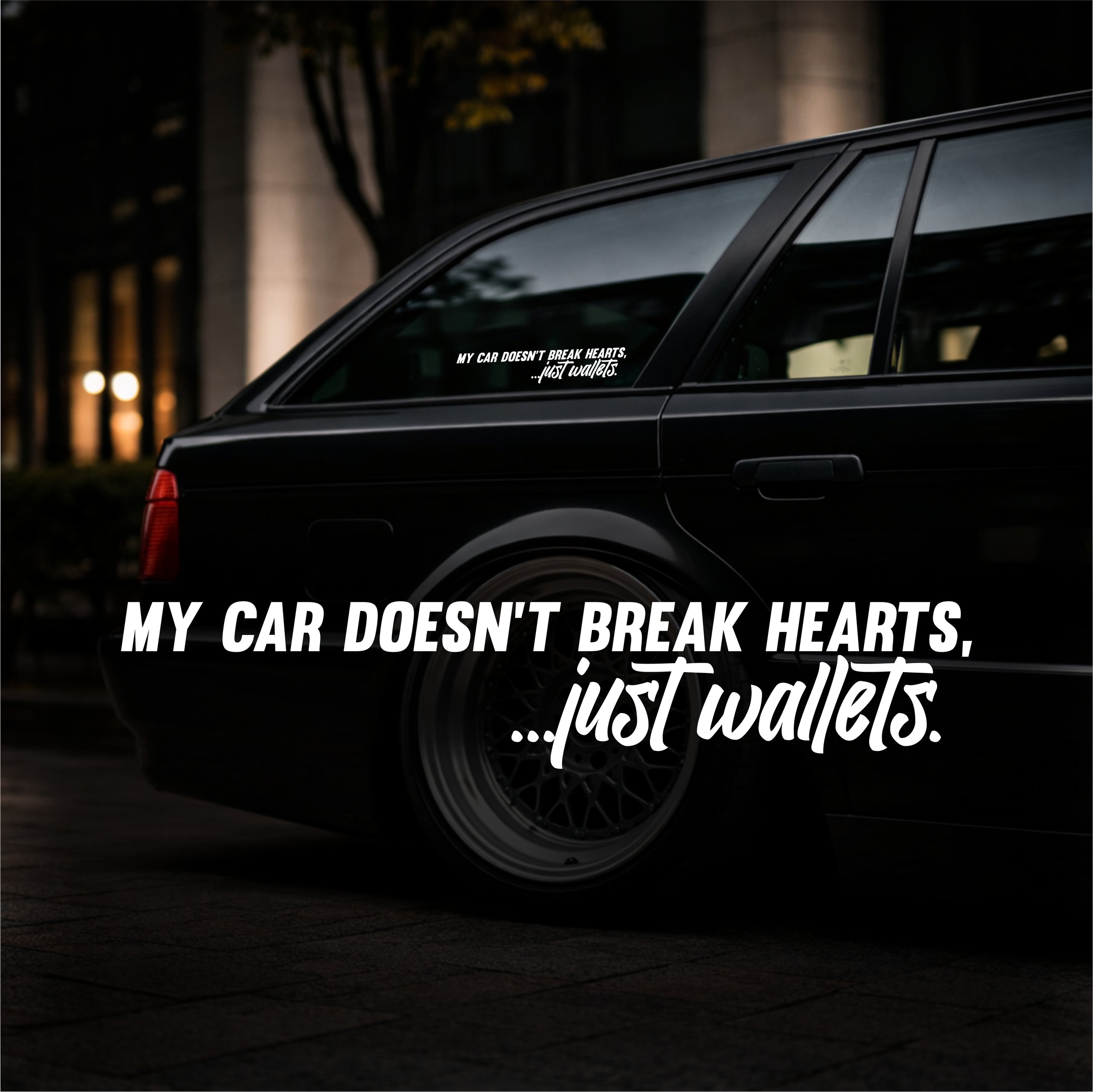 Black car with humorous text sticker at night