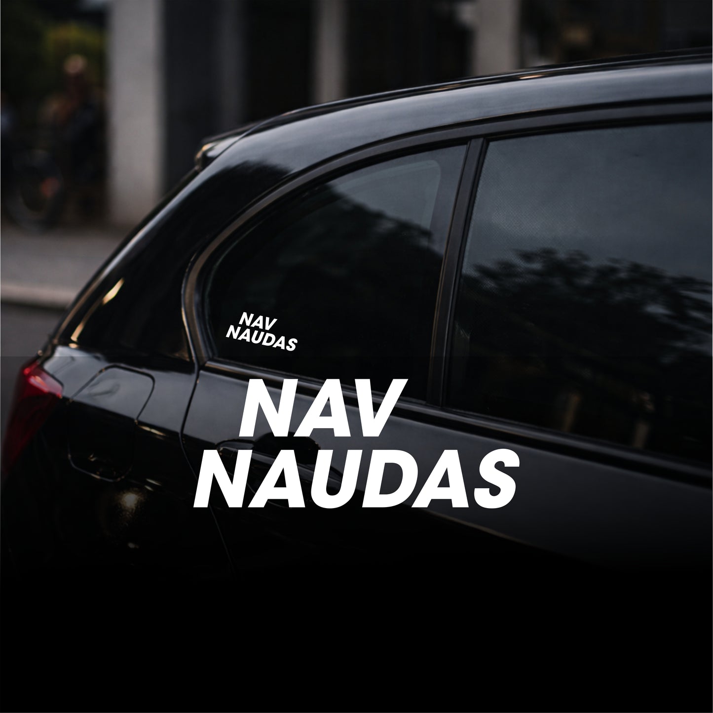 Black car with 'NAV NAUDAS' decal on a blurred background