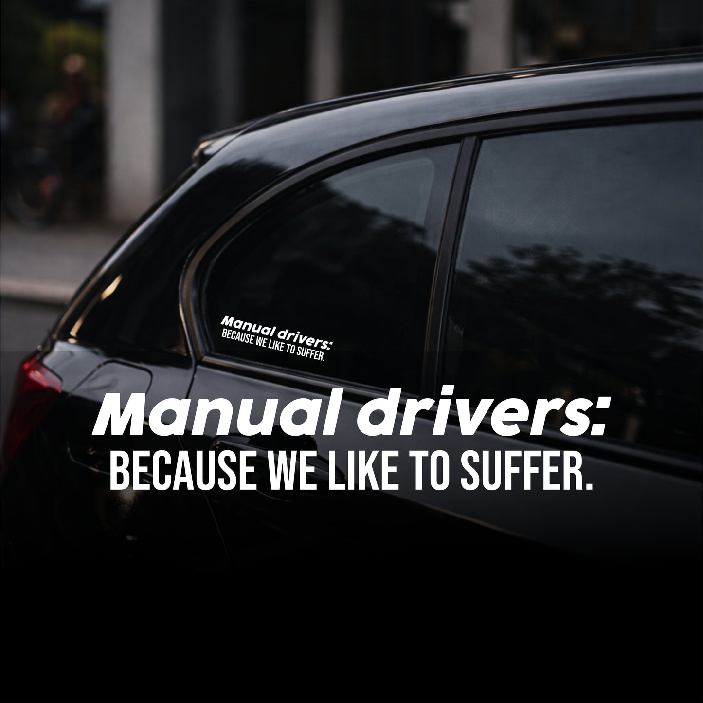 Car with a humorous sticker on the window, set against an urban background.