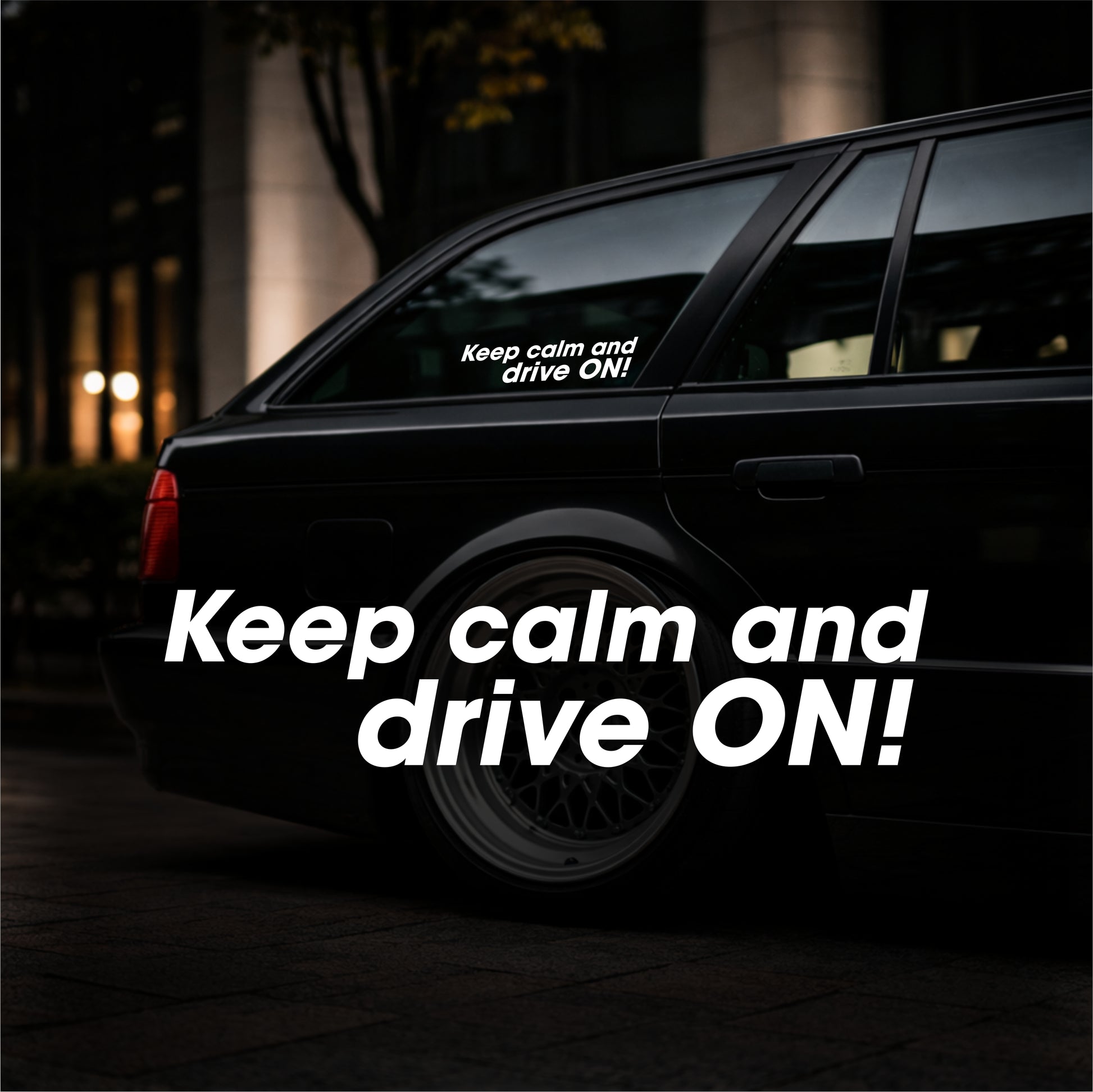 Black car with 'Keep calm and drive ON!' decal on a dark background