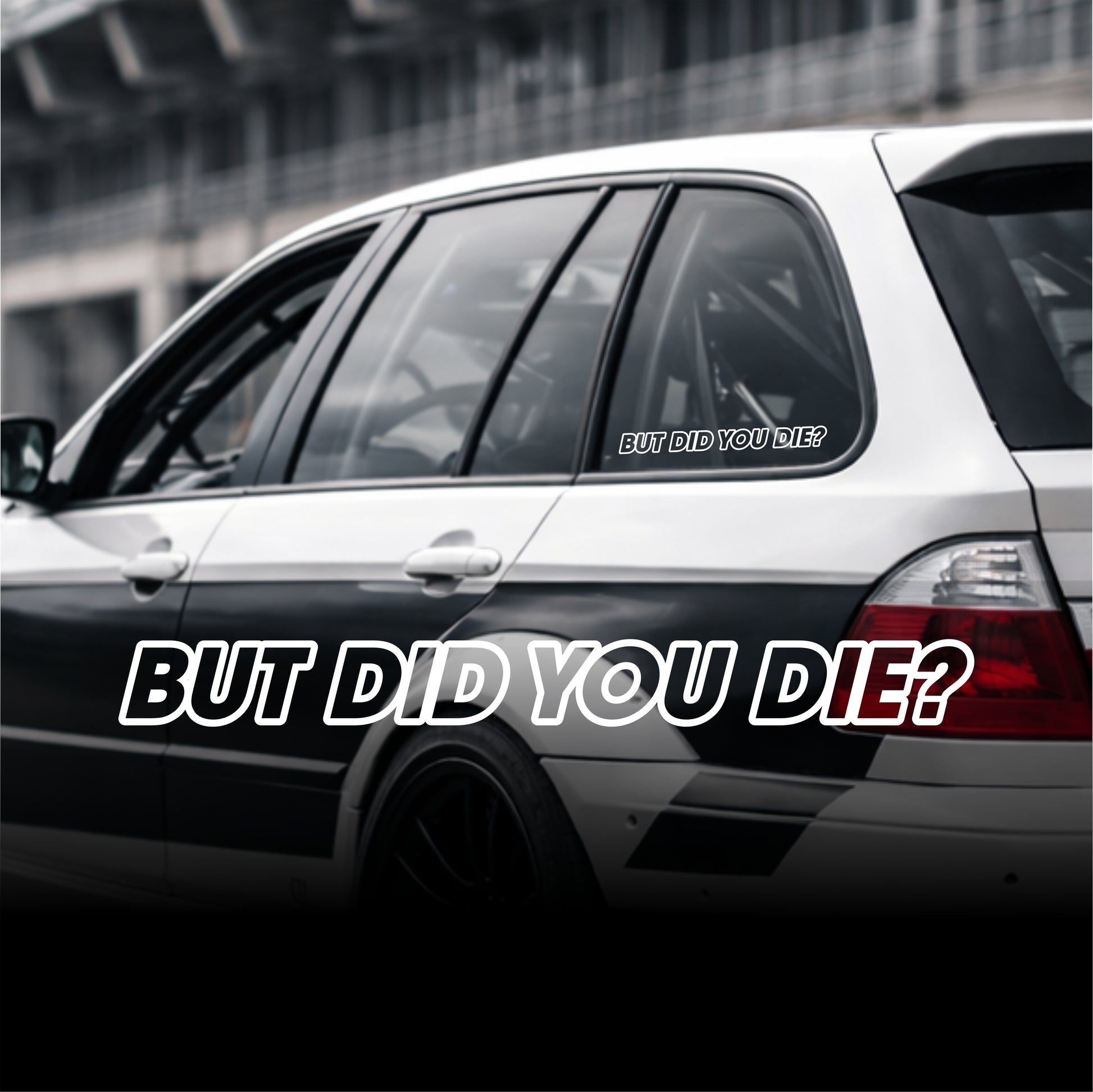 Car with 'BUT DID YOU DIE?' decal on a blurred background