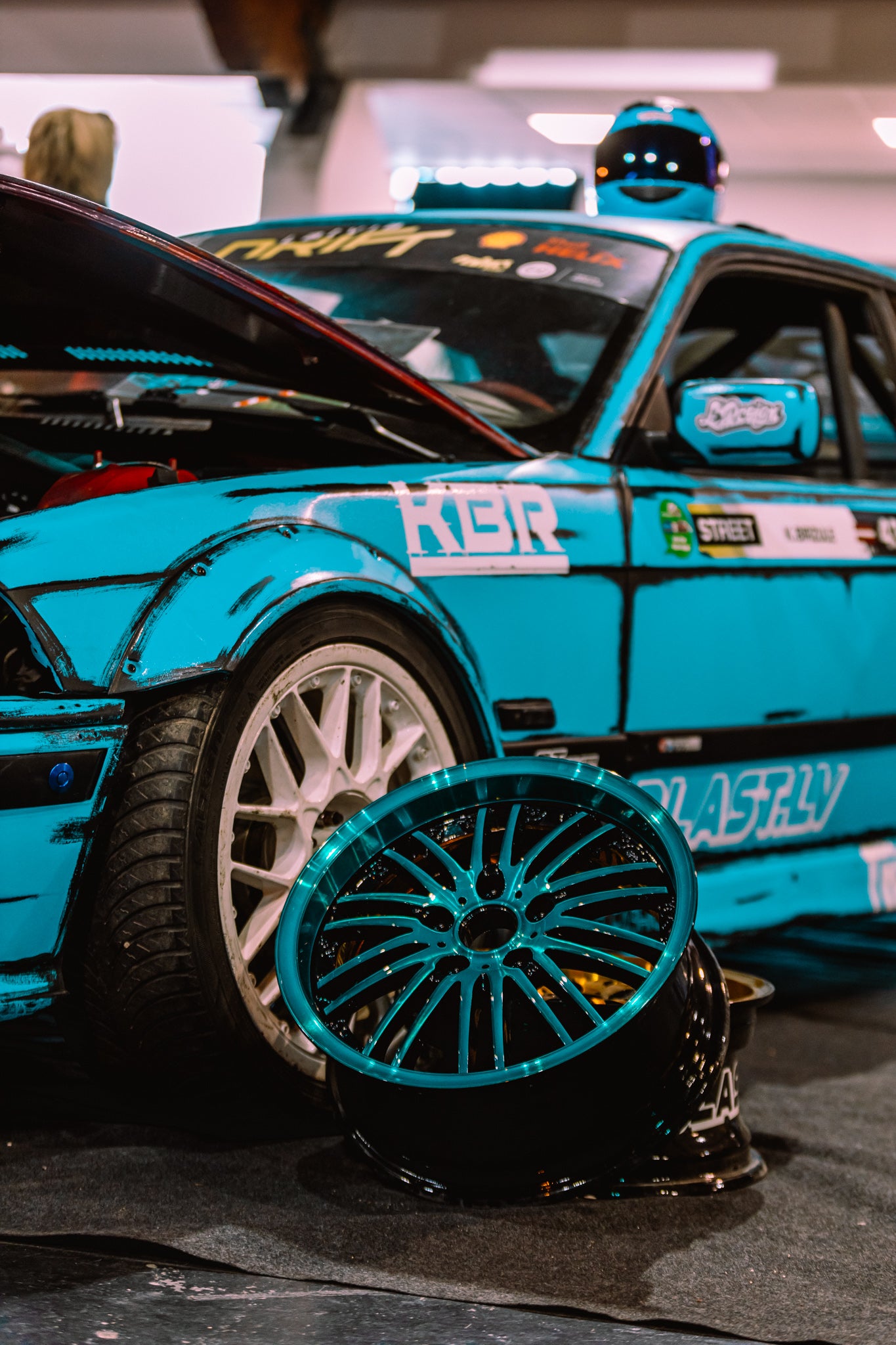 Close-up of a blue car with a detailed wheel, featuring the brand 'RGR'.