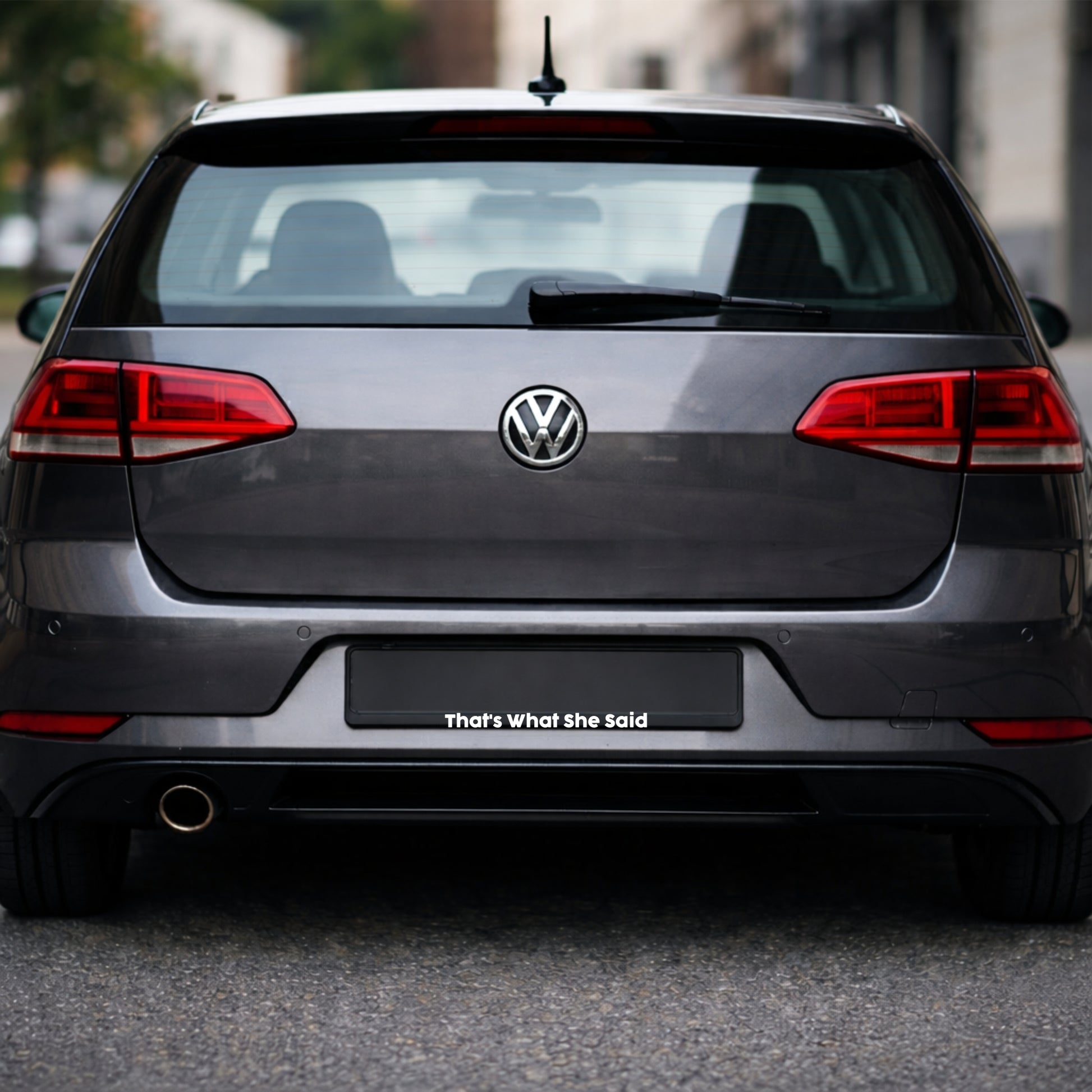 Back view of a Volkswagen car with a humorous license plate.