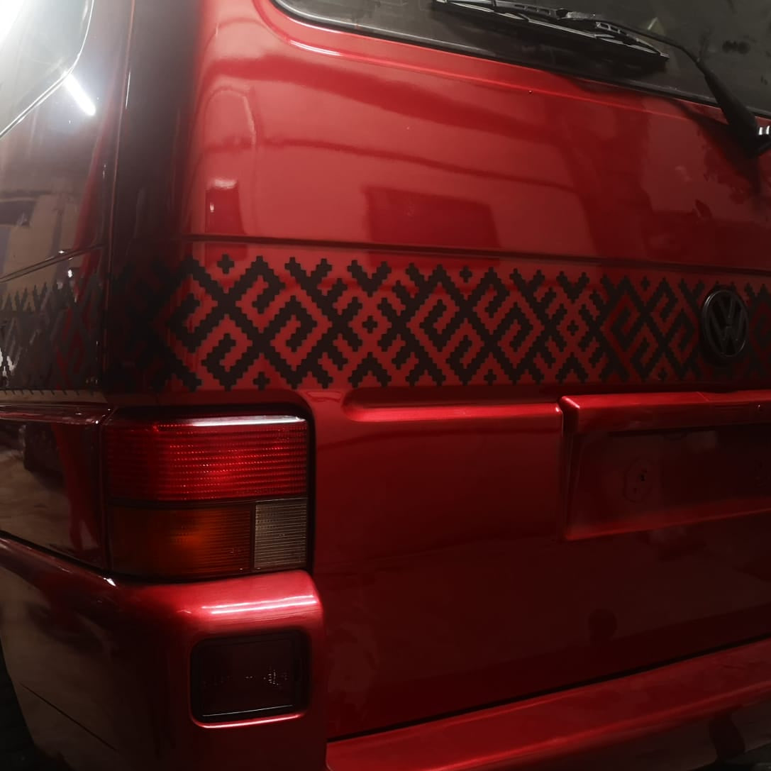 Red vehicle with geometric pattern on the back, taken with Huawei P20 Pro camera.
