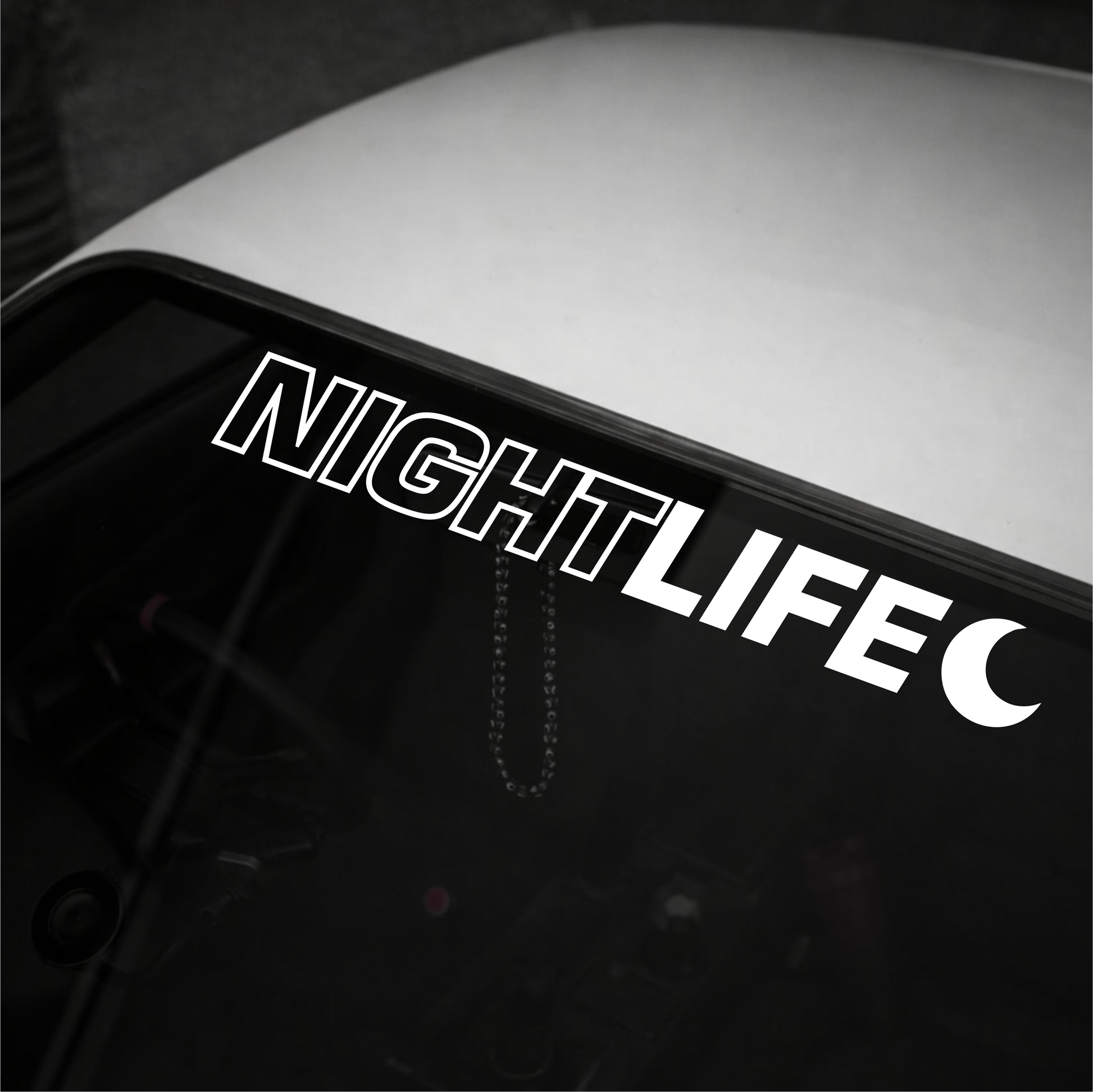 Decal with 'NIGHTLIFE' text on a vehicle's window