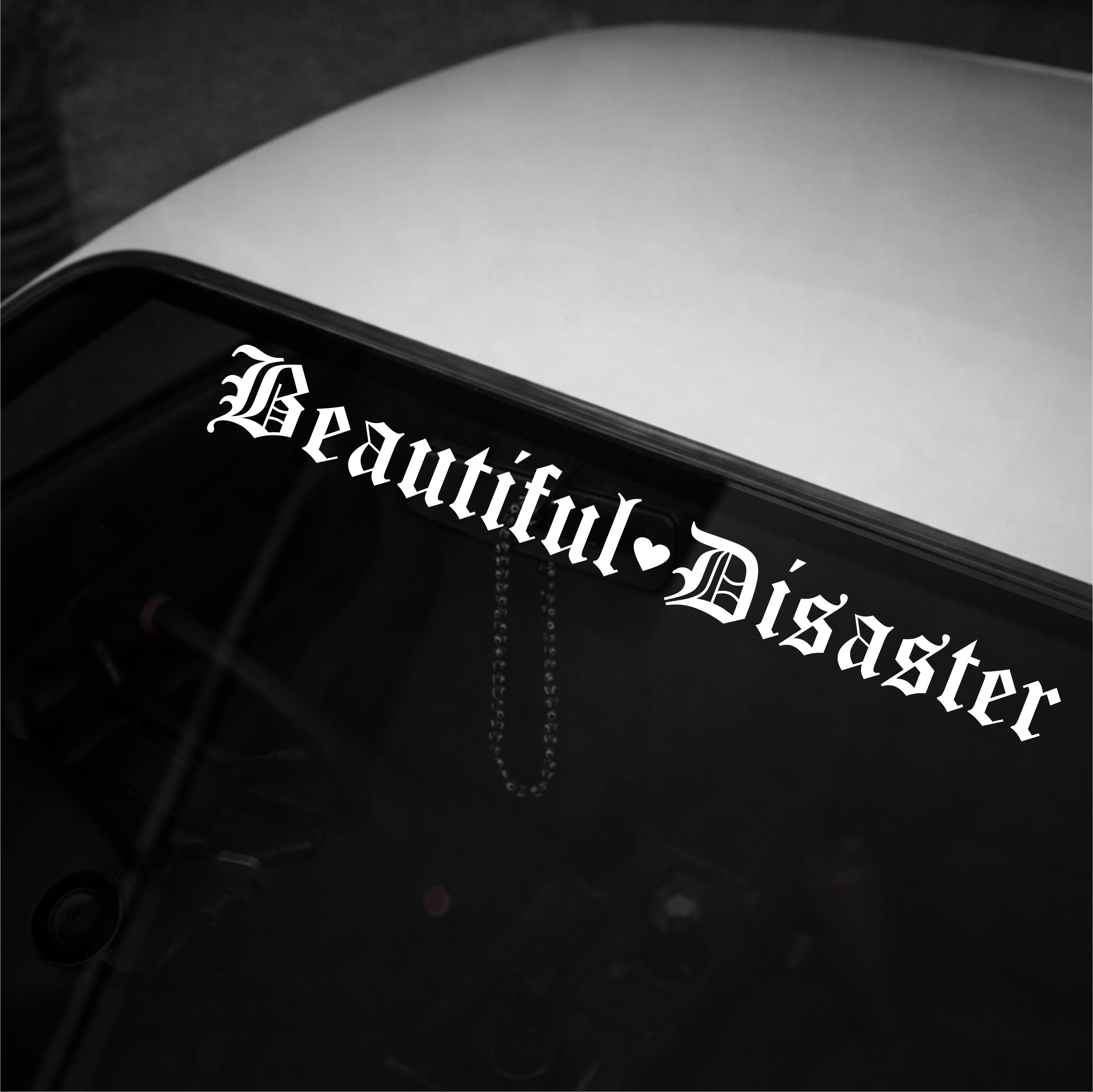 Sticker with 'Beautiful Disaster' text on a vehicle's window