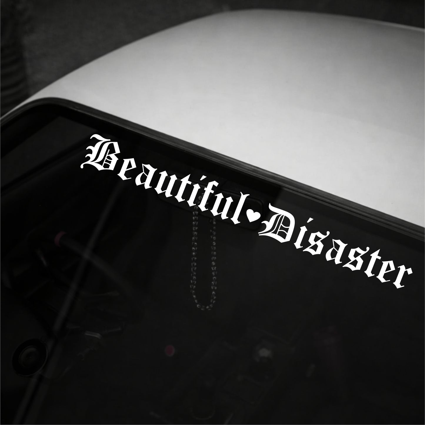 Sticker with 'Beautiful Disaster' text on a vehicle's window