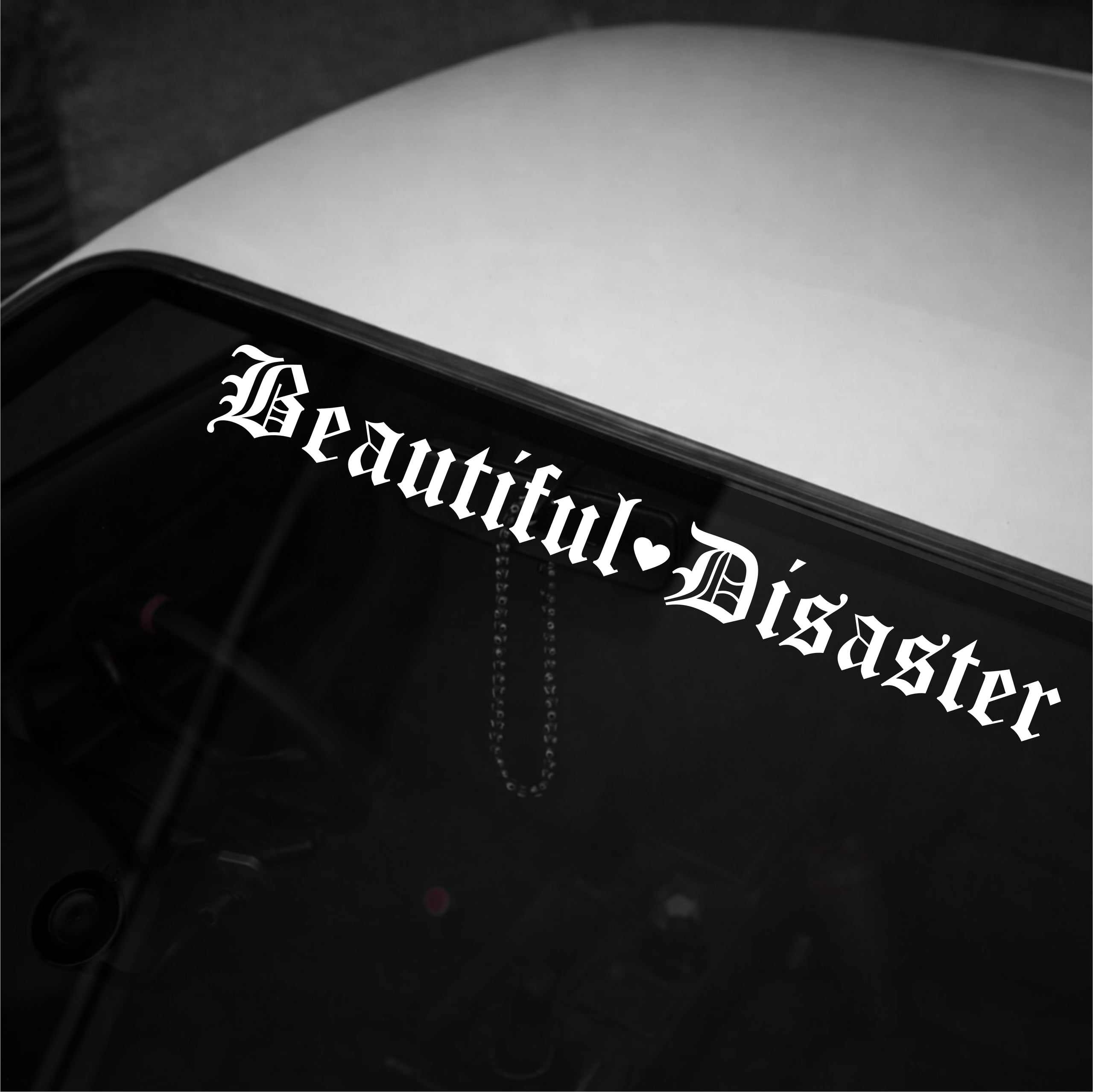 Sticker with 'Beautiful Disaster' text on a vehicle's window