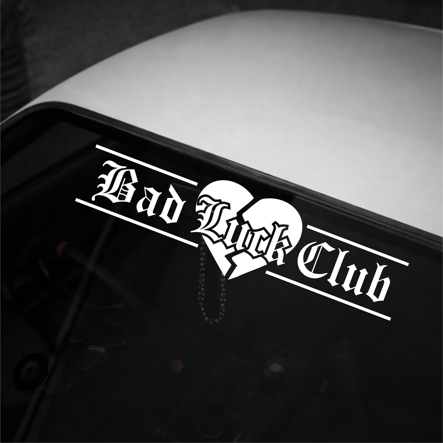 Sticker with 'Bad Luck Club' text on a vehicle's window