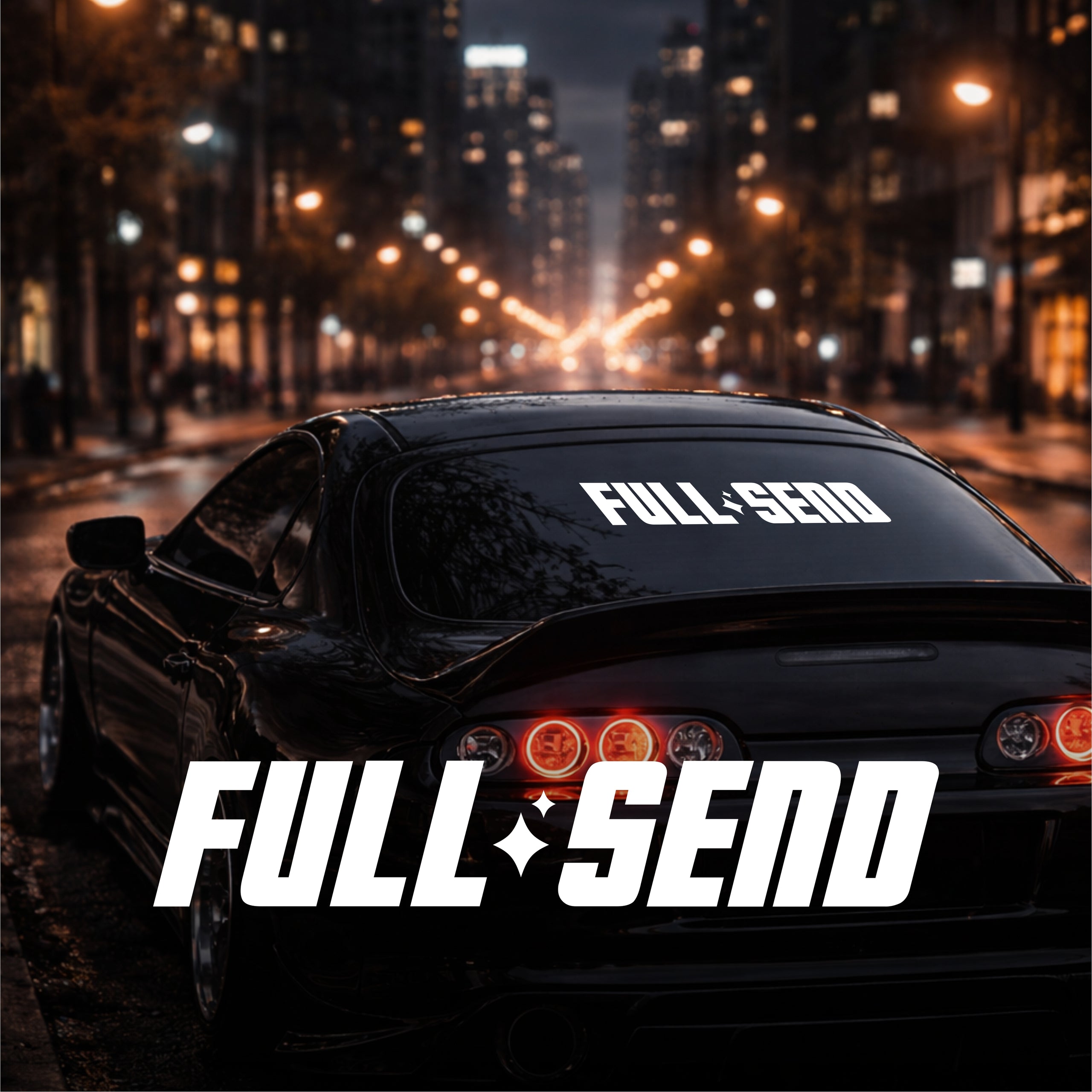 Car with 'FULL SEND' branding on a city street at night
