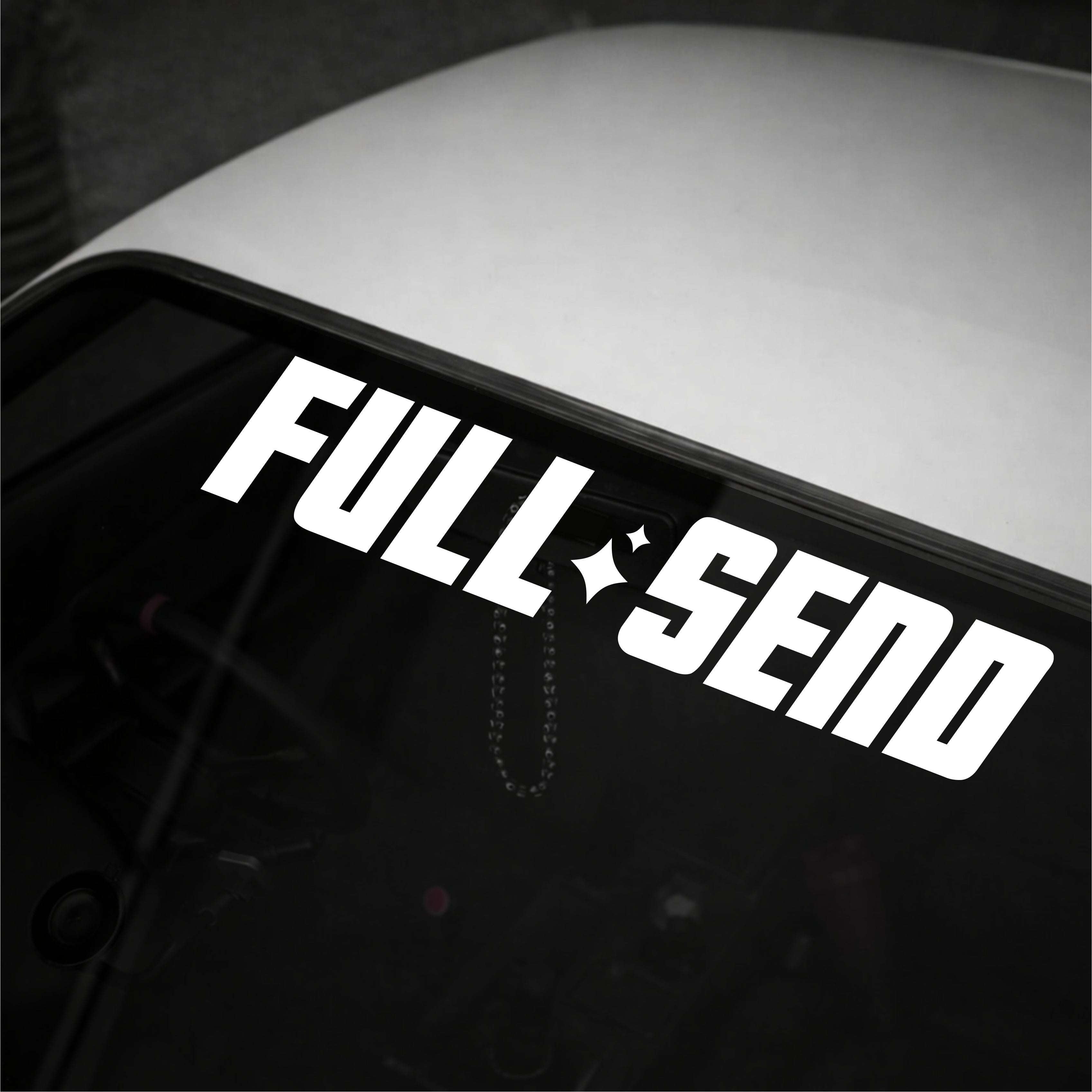 White 'FULL SEND' decal on a car window