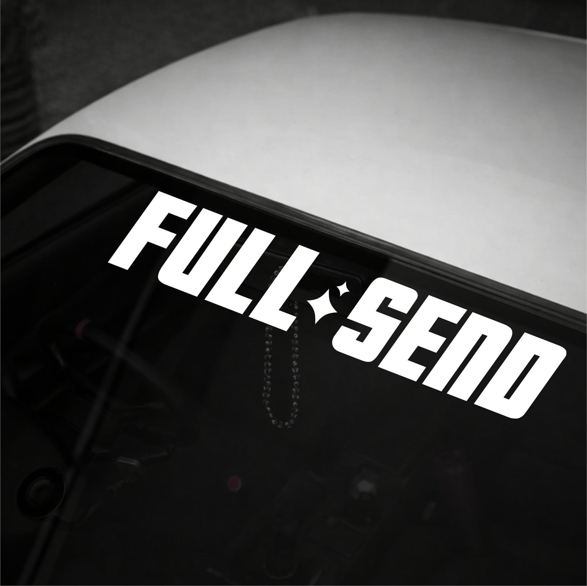 White 'FULL SEND' decal on a car window
