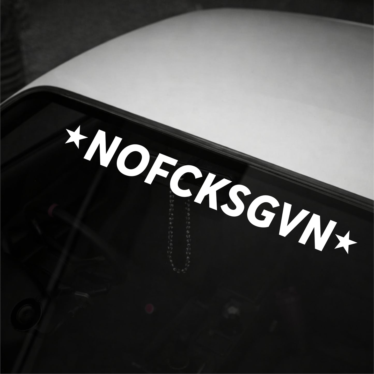 Decal with 'NOFCKSGVN' text on a vehicle window