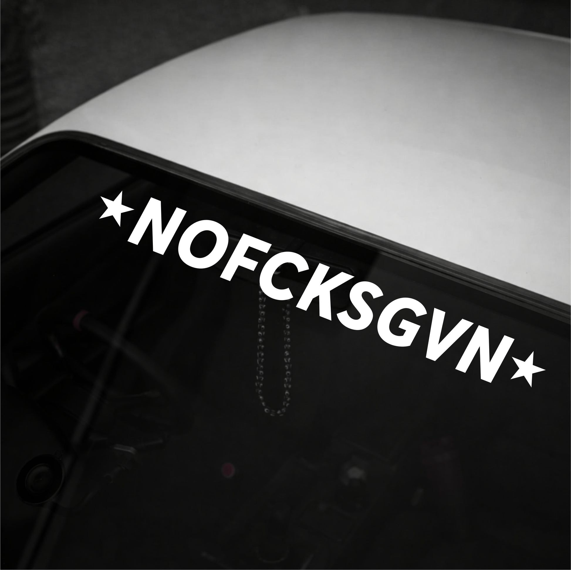 Decal with 'NOFCKSGVN' text on a vehicle window