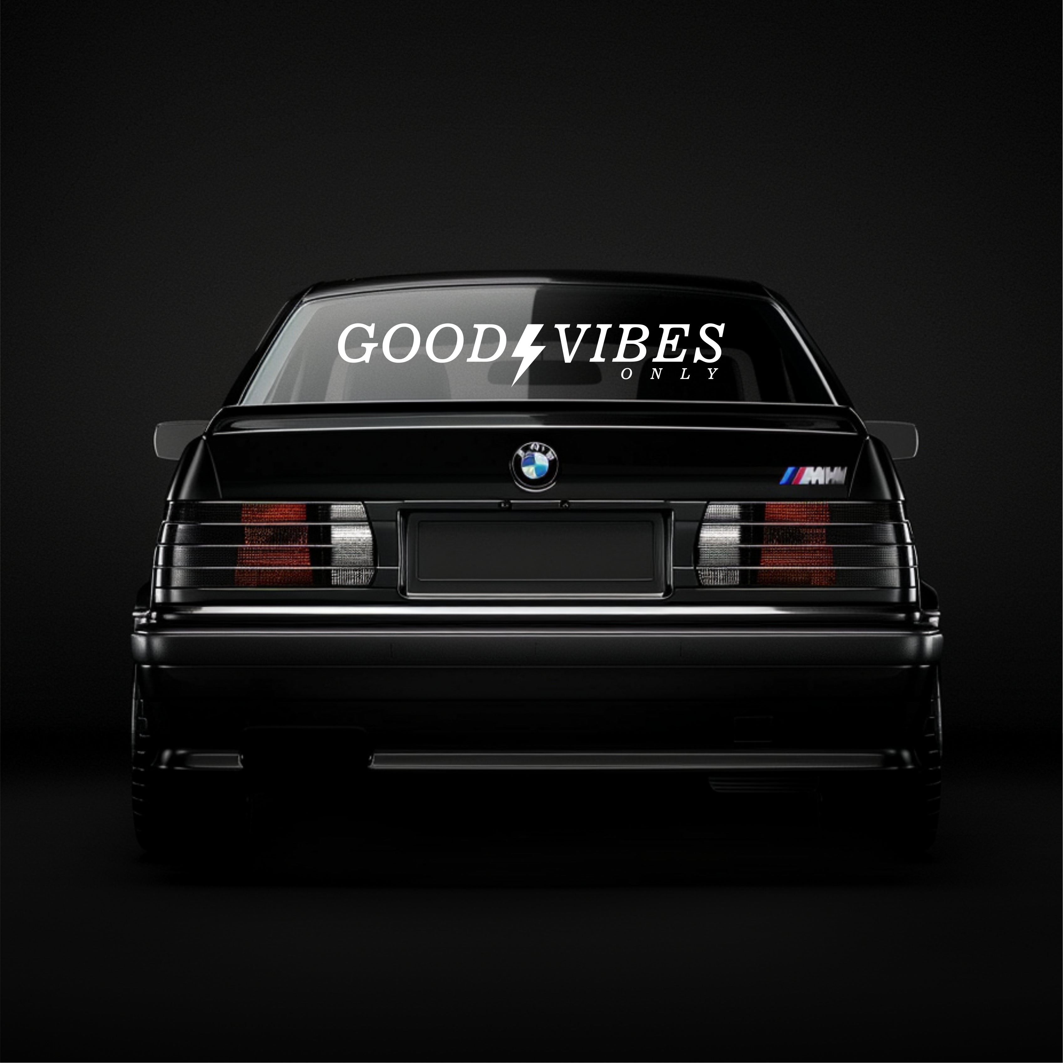 BMW car with 'Good Vibes Only' decal on a black background