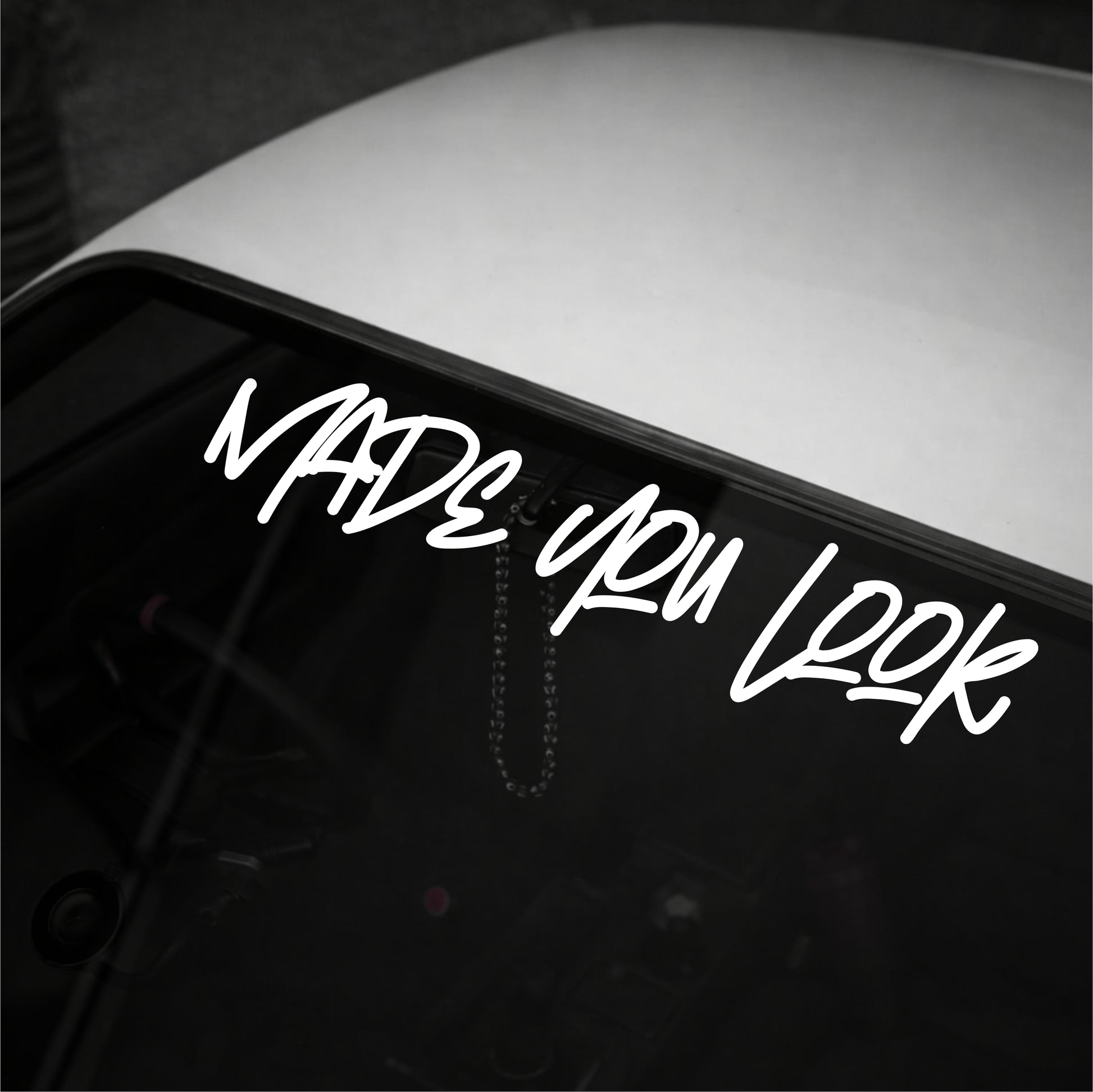 Neon sign with 'Made You Look' text on a dark background