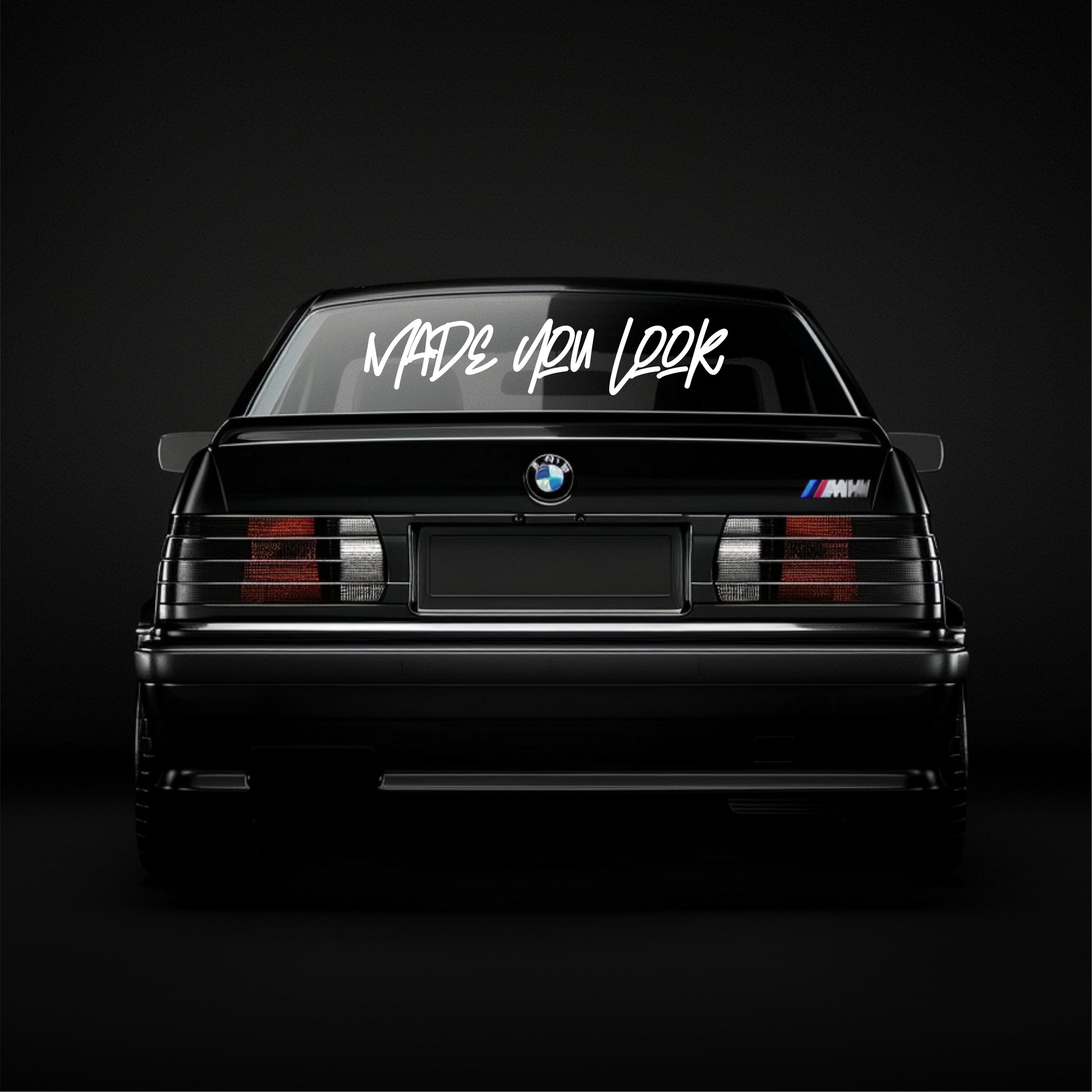 BMW car with 'Made You Look' text on a black background