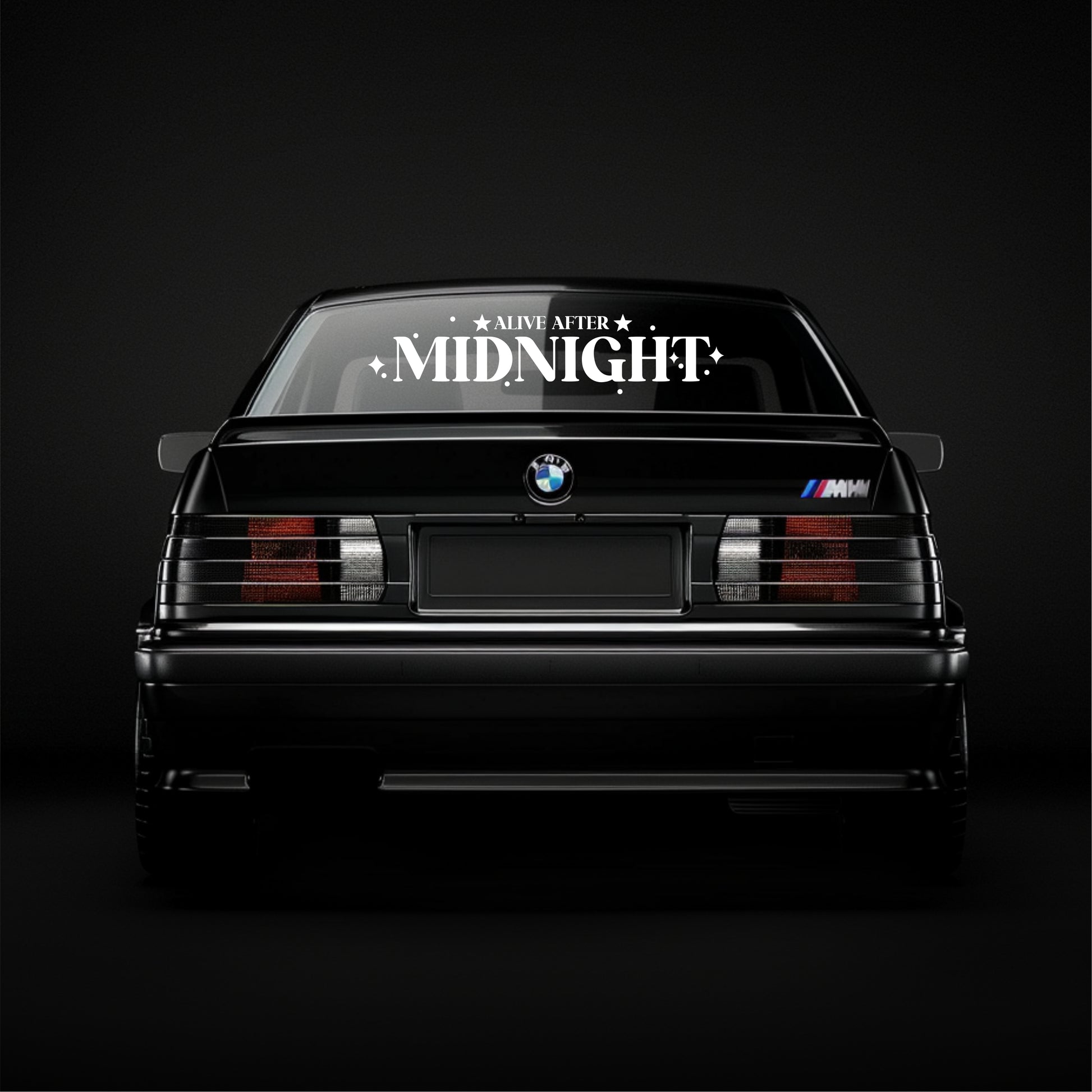 BMW car with 'Alive After Midnight' decal on a black background