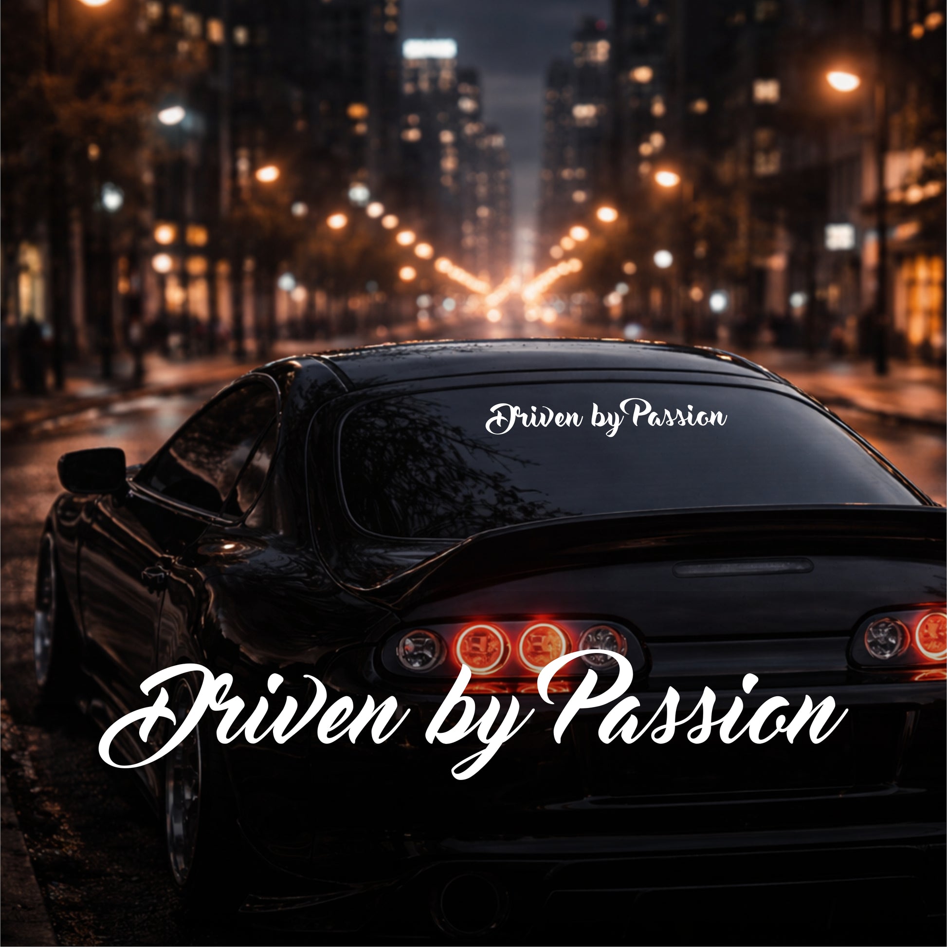 Car with 'Driven by Passion' decal on a city street at night