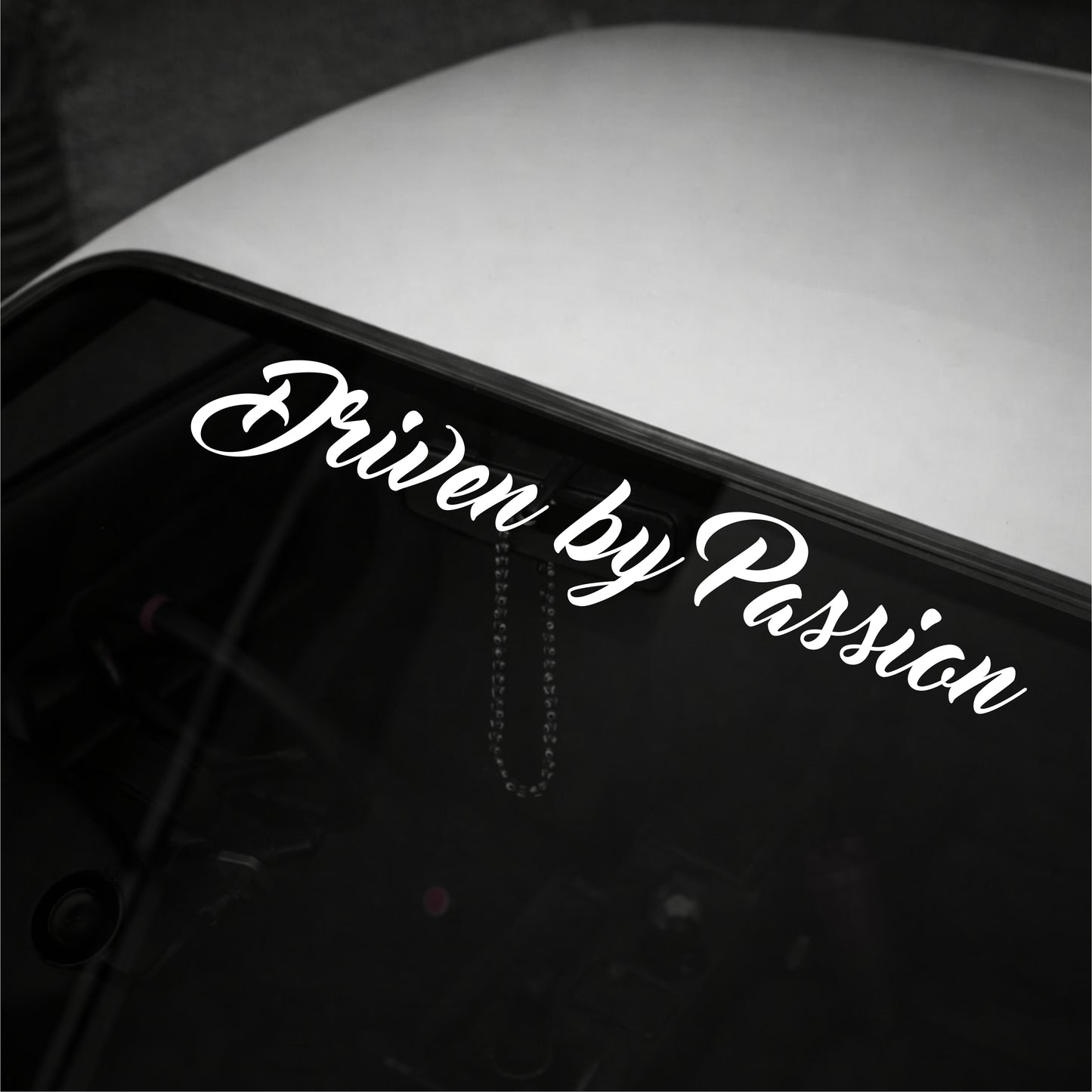 Car window with 'Driven by Passion' decal in white text on a black background