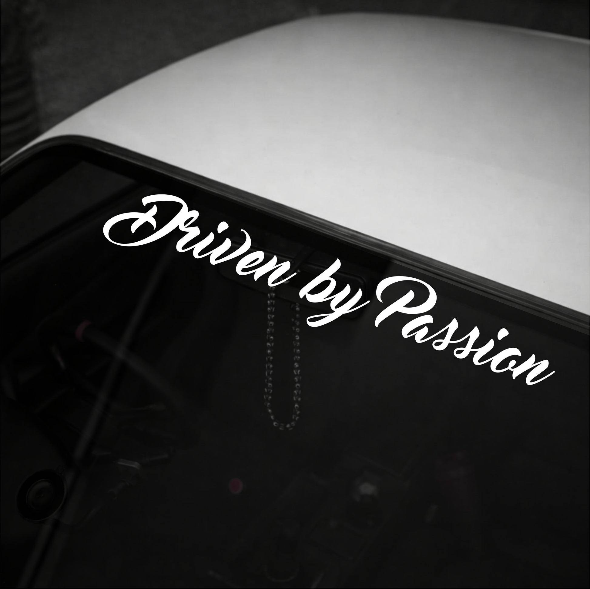 Car window with 'Driven by Passion' decal in white text on a black background