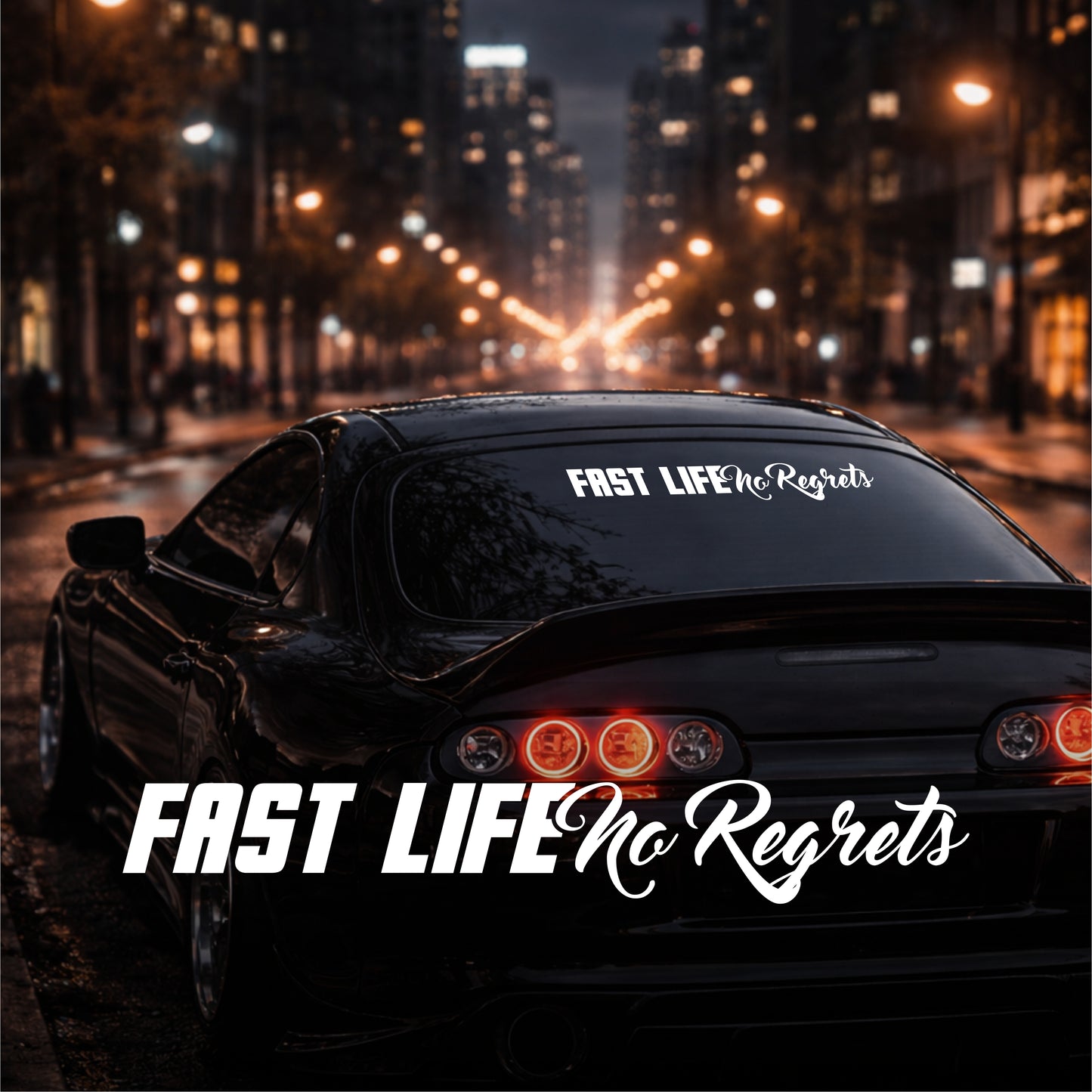 Car with 'Fast Life No Regrets' decal on a city street at night