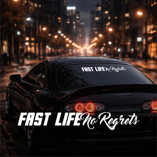 Car with 'Fast Life No Regrets' decal on a city street at night