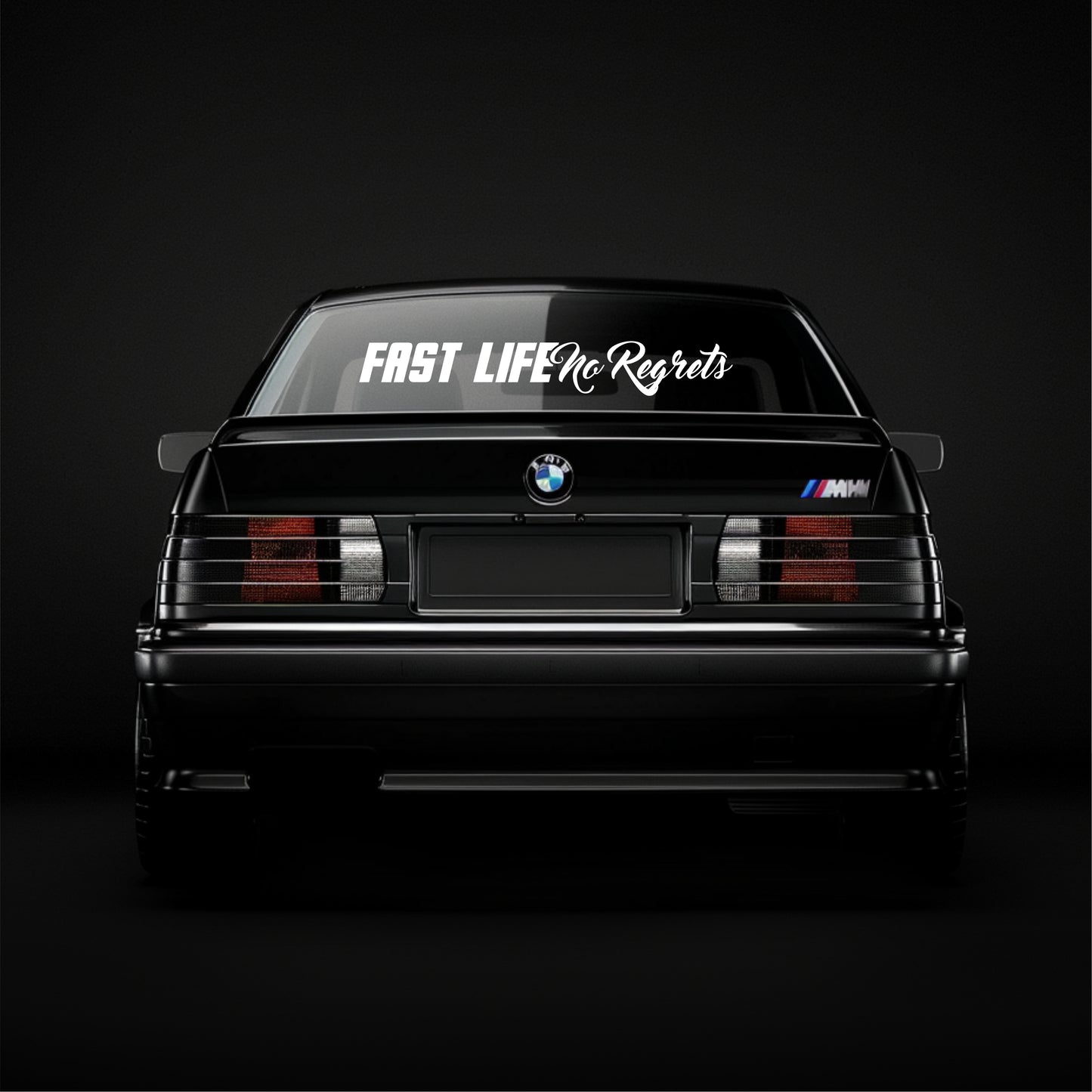 BMW car with 'Fast Life No Regrets' decal on a black background