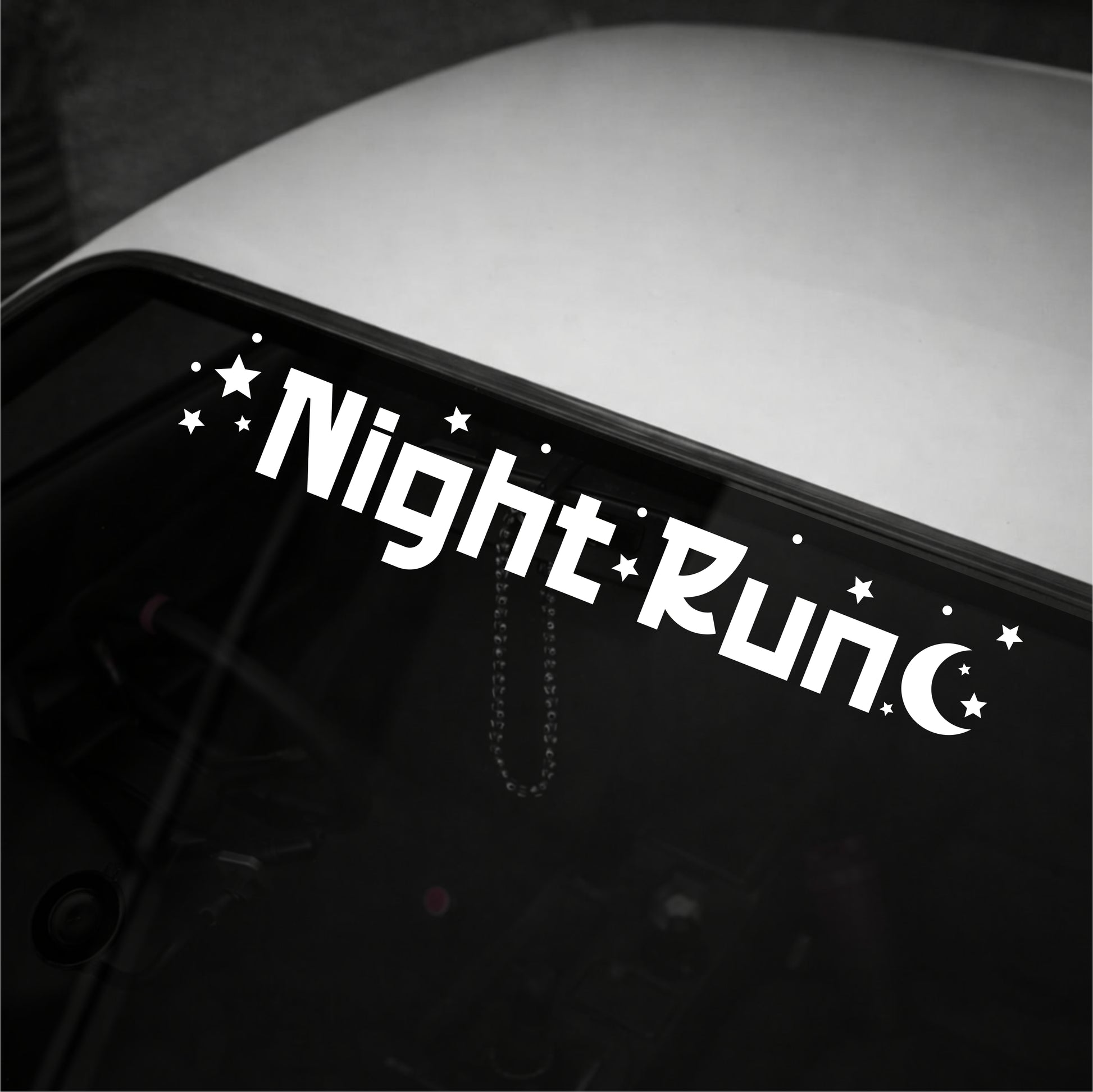Decal with 'Night Run' text on a vehicle's window