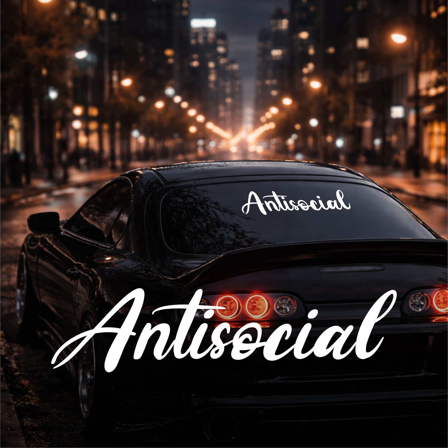 Car with 'Antisocial' decal on a city street at night