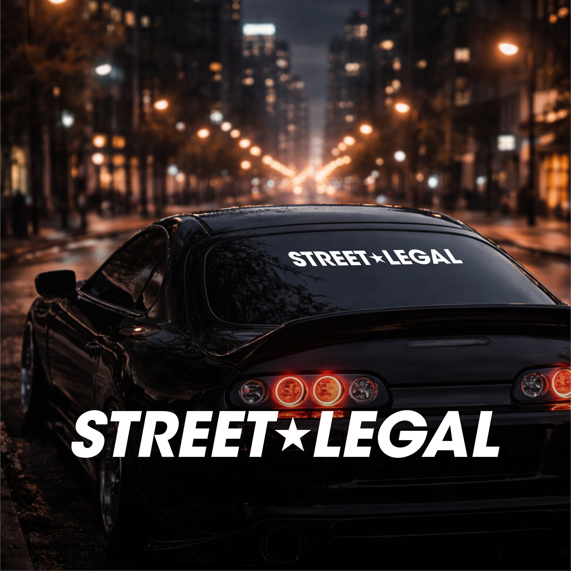 Car with 'Street Legal' decal on a city street at night