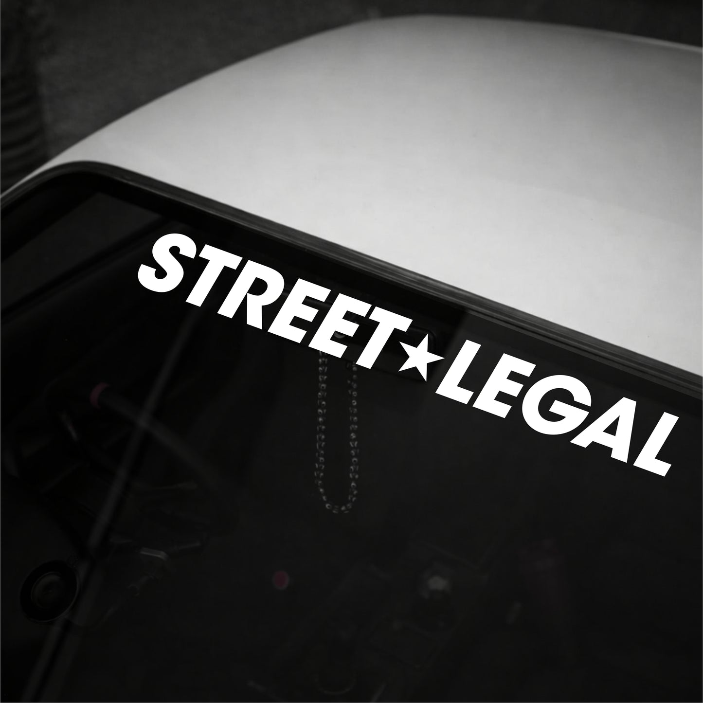 Decal with 'STREET LEGAL' text on a vehicle window