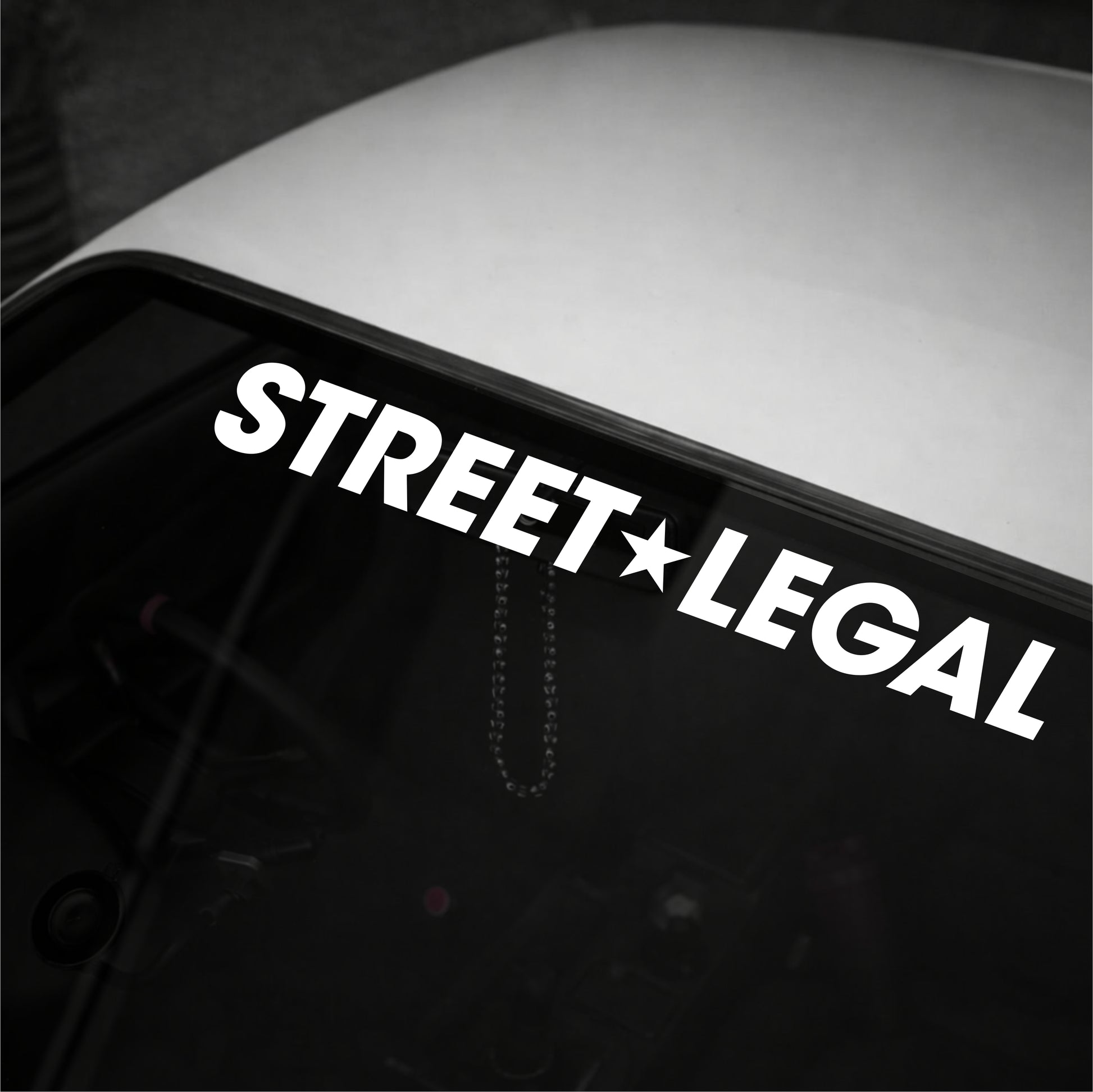 Decal with 'STREET LEGAL' text on a vehicle window
