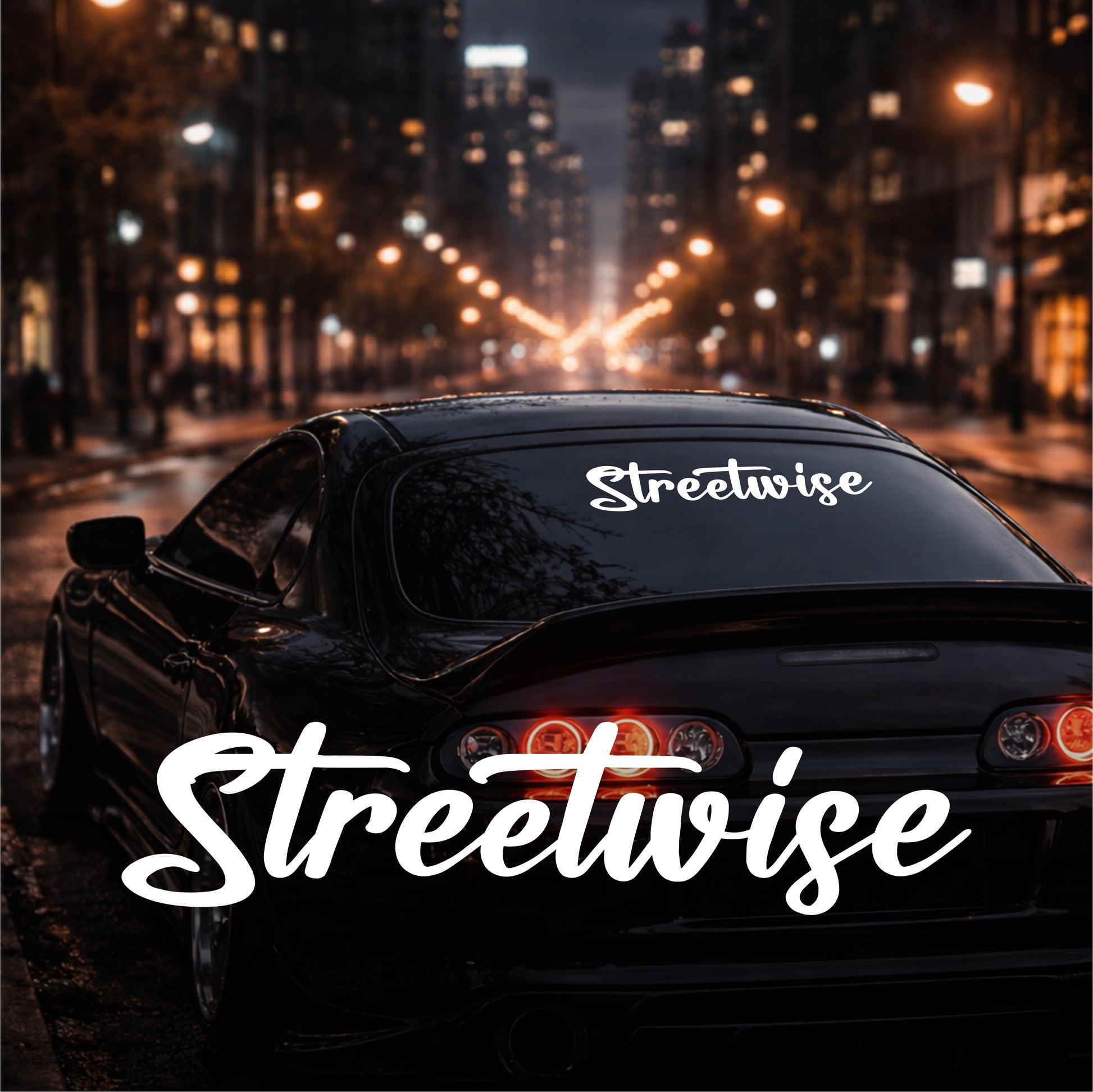 Car with 'Streetwise' decal on a city street at night