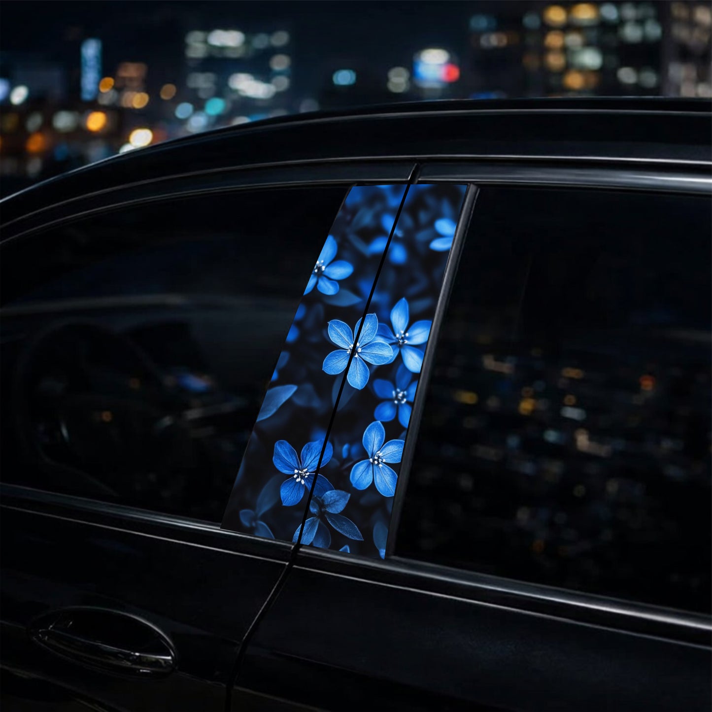 Car window with a blue floral design decal against a cityscape background